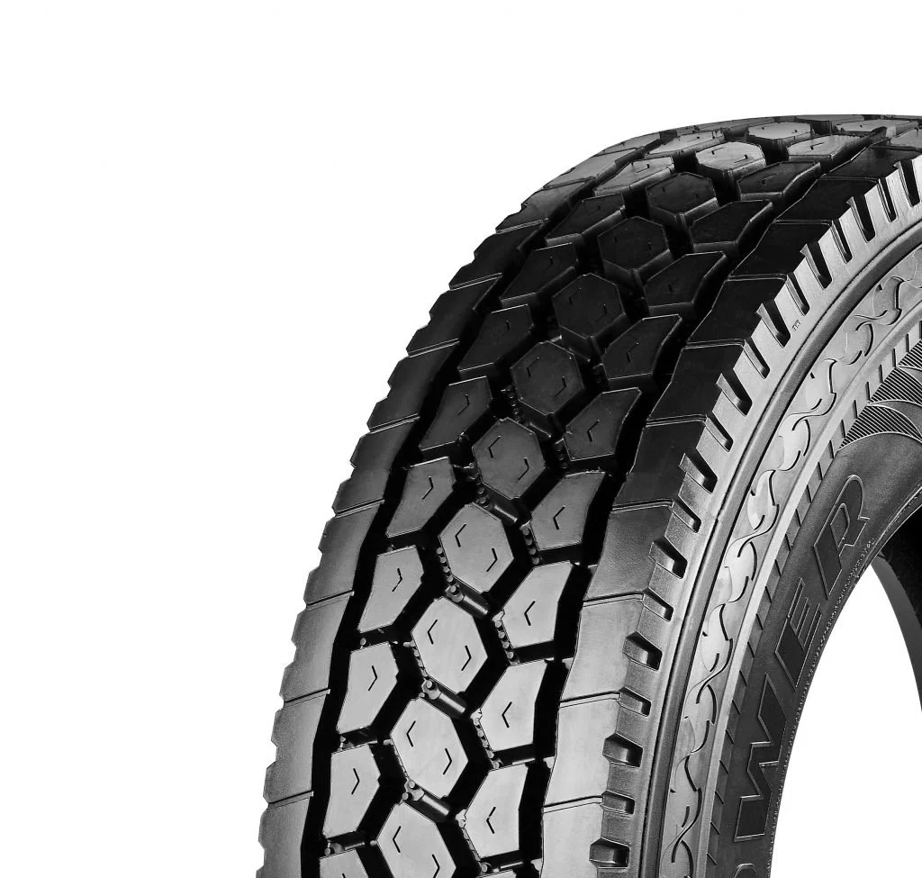 Windpower WGC28. Close-up of a black tire with a rugged tread pattern, isolated against a white background.