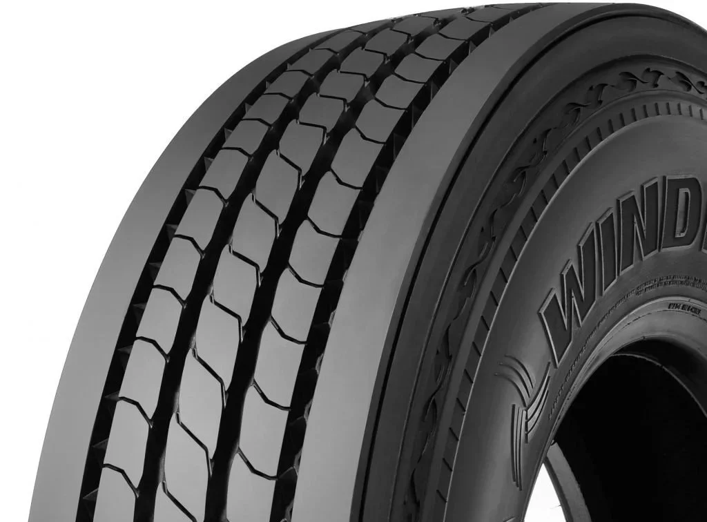 Close-up of a black tire with detailed tread pattern and the words "WIND" imprinted on its sidewall.