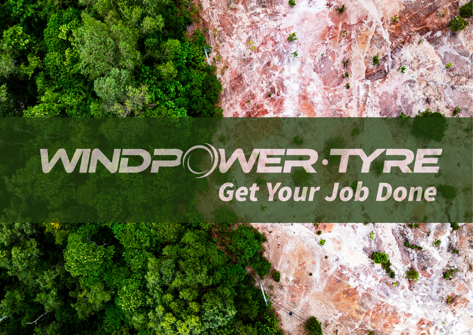 Aerial view of a forest and a cleared area with the logo 'WindPower Tyre' and the tagline 'Get Your Job Done' overlayed in the center.