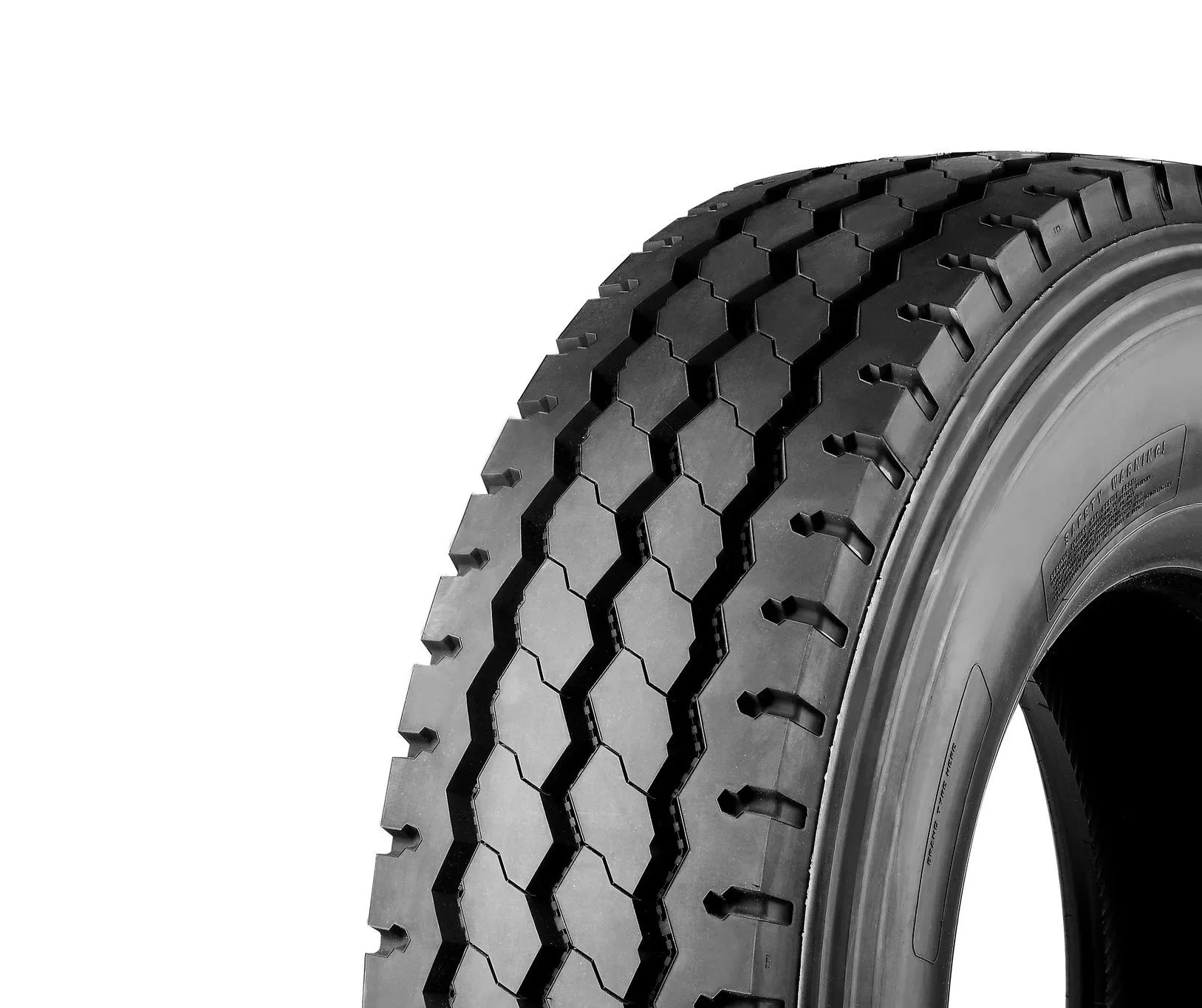 Windpower WGR26 All position Tyre. Close-up of a black, rugged tire with a hexagonal tread pattern on a plain white background.