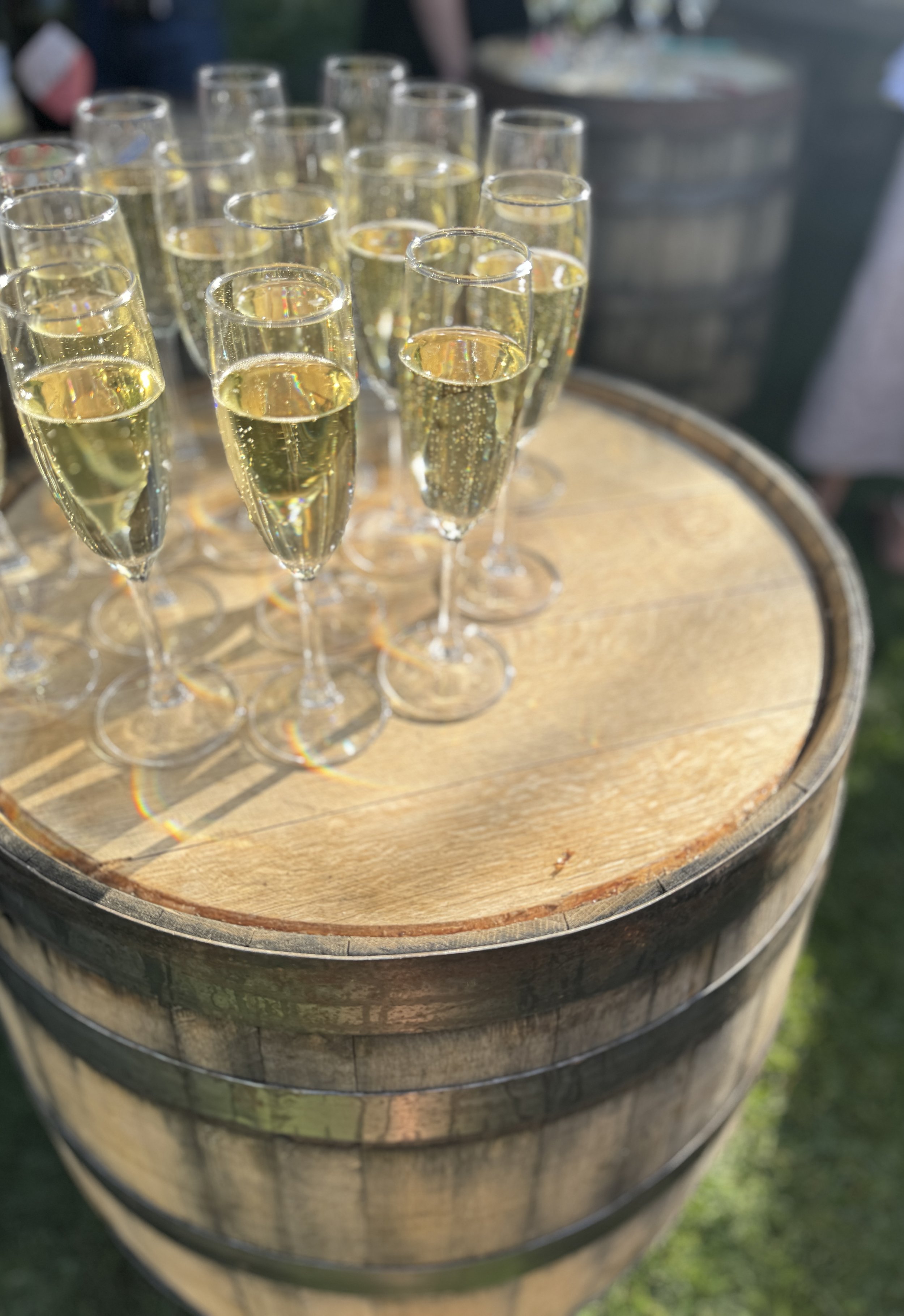 Glass of champagne on a wooden barrel.