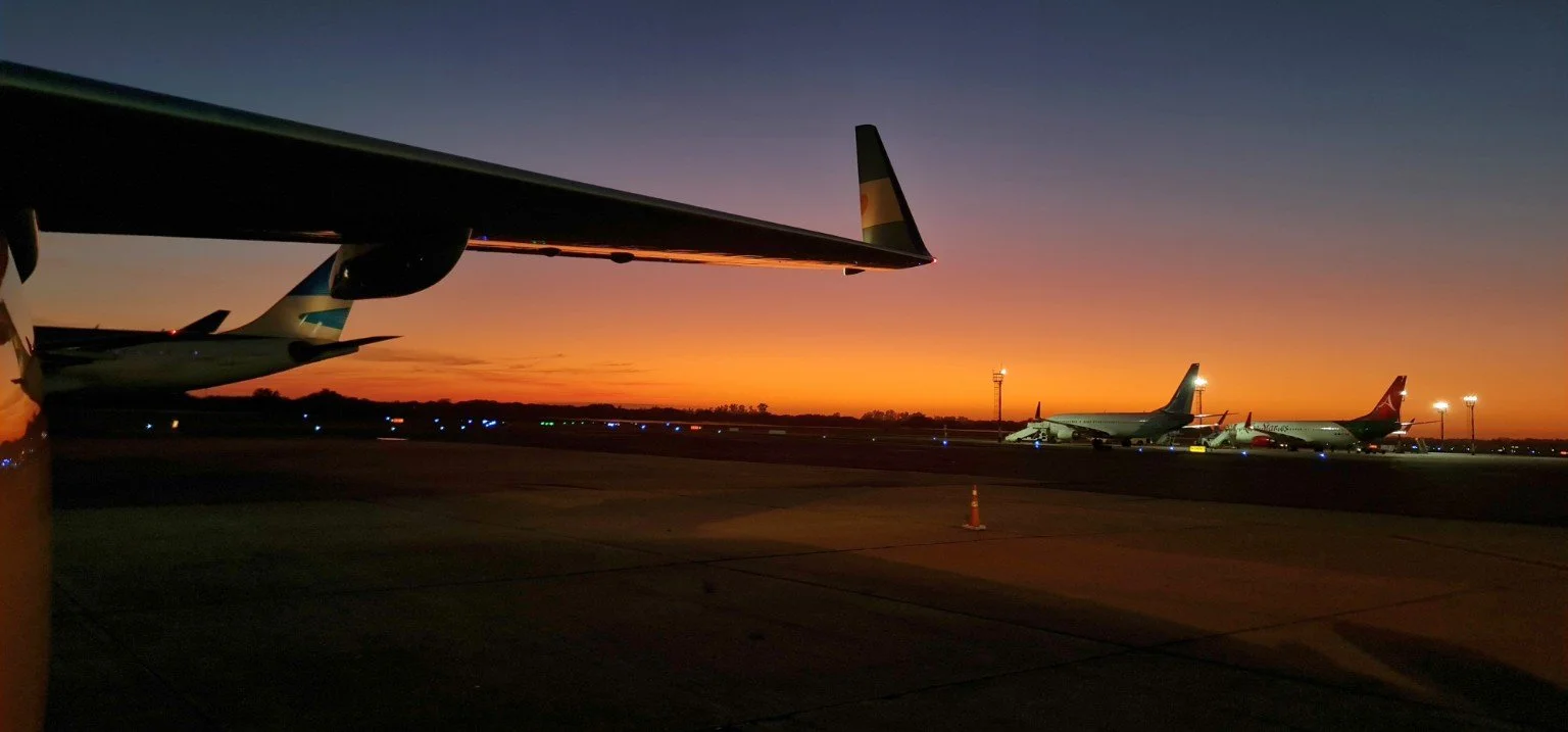 AirOps Vector aviation consulting — aircraft on the ramp at sunset, representing airline operations, safety services, and professional ferry flights.