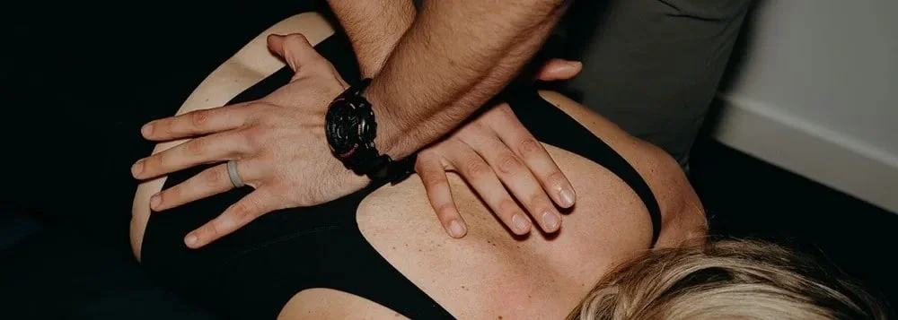 A person receiving a back massage from a massage therapist.