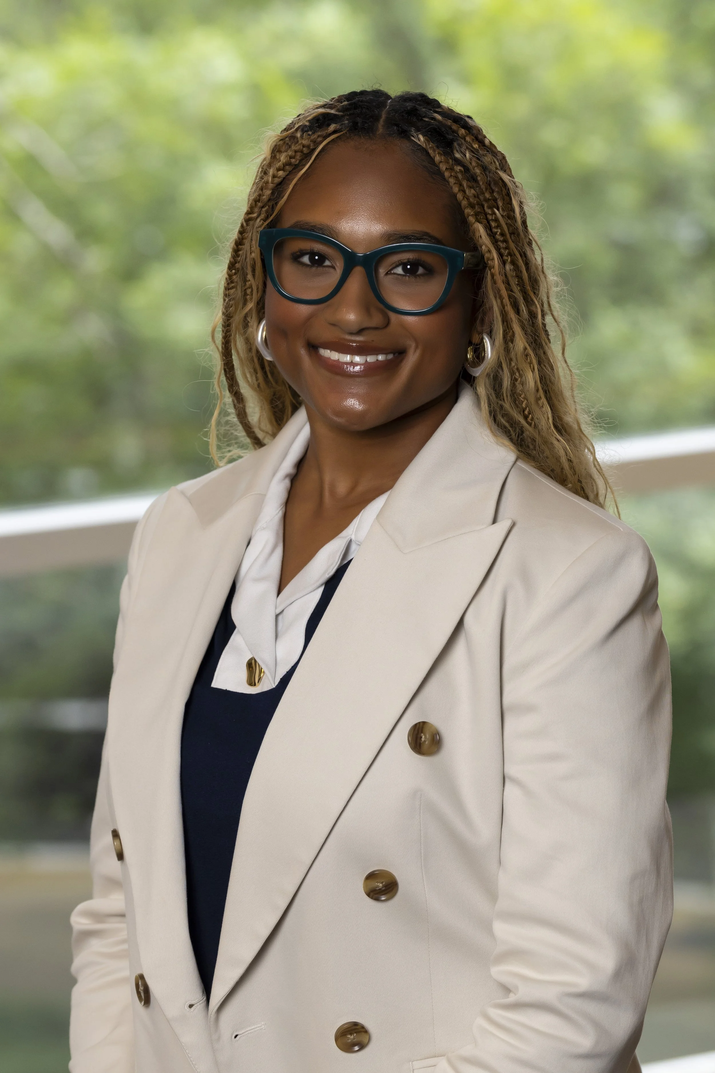Kelsey Barnes, founder of Frané Consulting, culture-led beauty and wellness marketing strategist, smiling in a cream blazer.