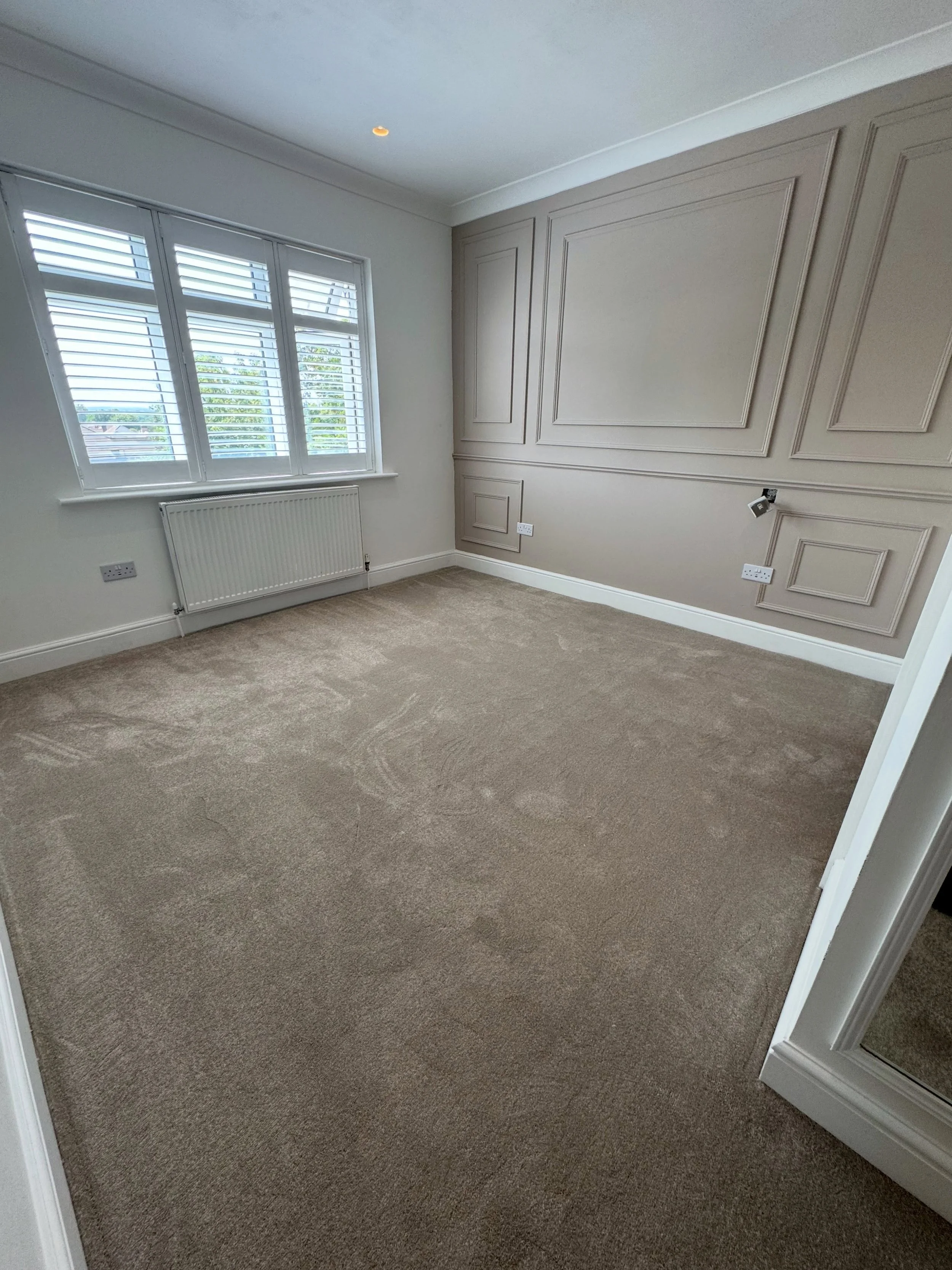 Is this possibly the perfect neutral bedroom? Hard wearing yet soft underfoot, Highgrove Elite colour Fez compliments the wall colour to create a calm and relaxing space to unwind.  #neutral #carpet #panelling #bedroomdesign