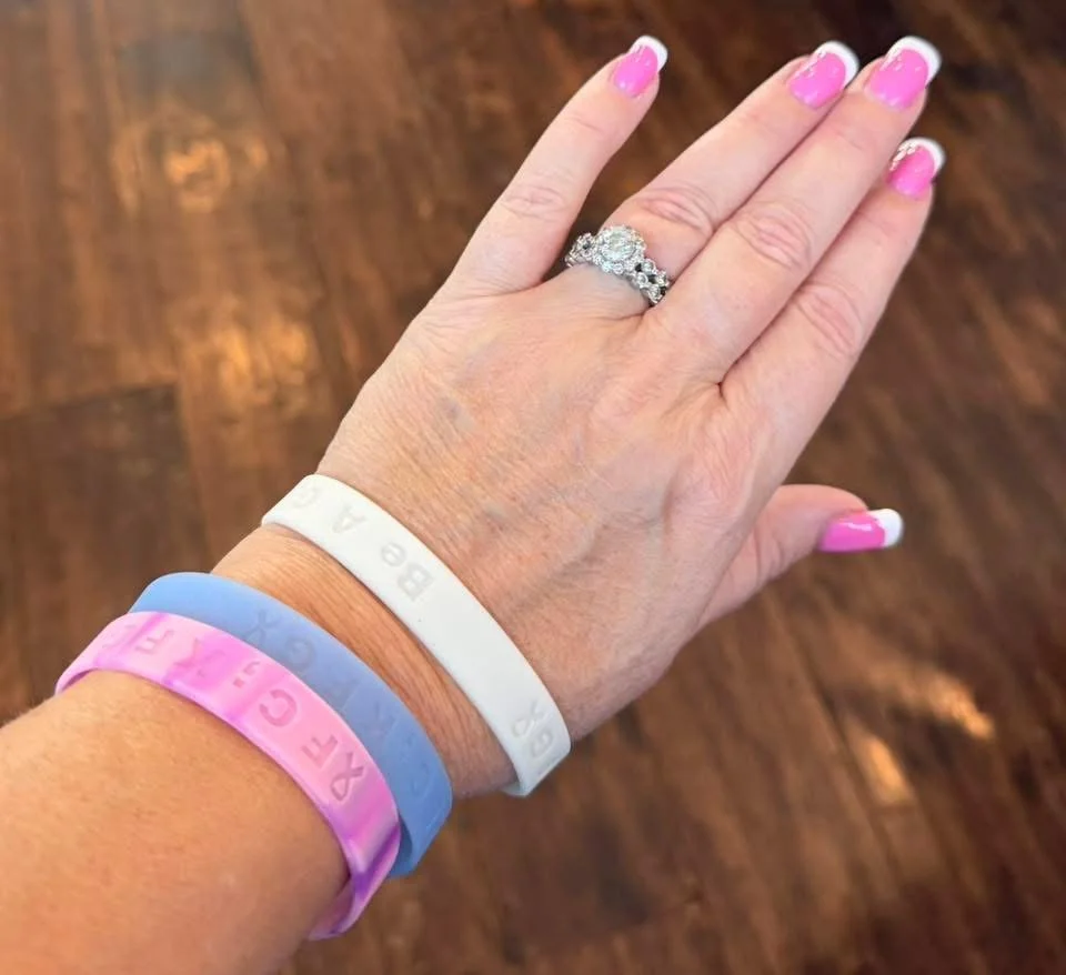 Stackable debossed silicone wristbands in pink, blue, and white—clean, comfortable, and made to share a positive message every day.  Be A Good Human Silicone Wristbands | Pink, Blue & White Debossed Bracelets.  Debossed Silicone Wristbands — Pink, Bl