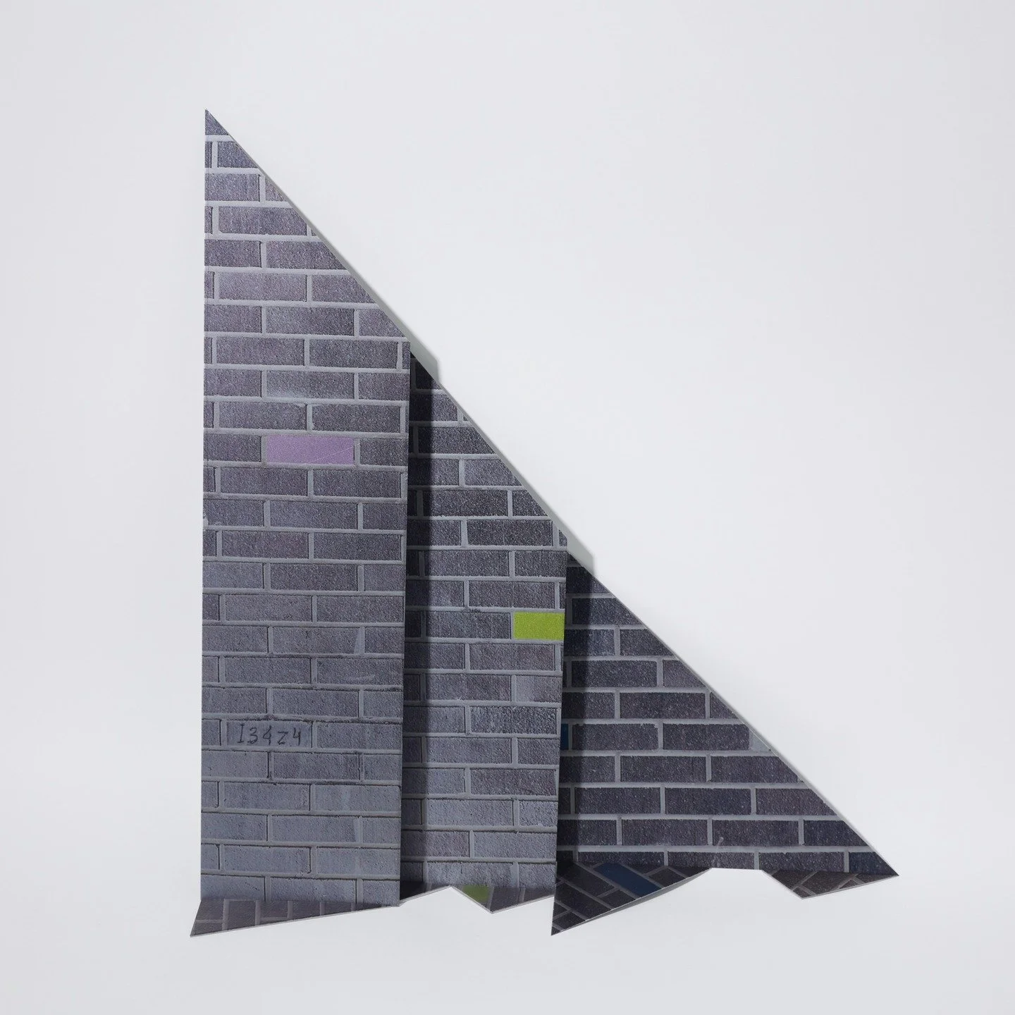 Bricked Out, UV Print on mild steel off-cuts, 30x38x10cm, 2025

Bricked Out explores fragmentation and coded meaning within urban structures, using printed metal off-cuts to evoke the facade of a broken wall or passage. The pops of colour and AI-gene