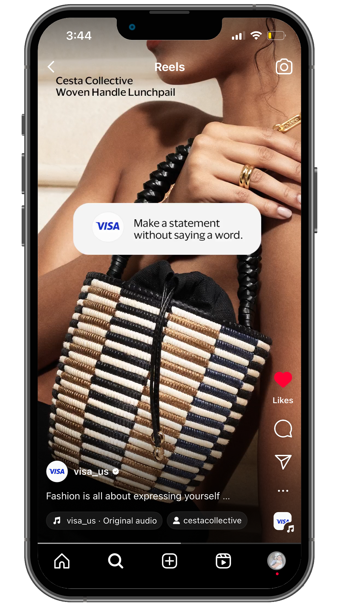 Close-up of a woman's upper body holding a woven handle lunchbox with a black strap and a geometric pattern. She is wearing gold rings and a gold necklace. The image is on a social media app interface with a caption about fashion and a prompt to make a statement without words.