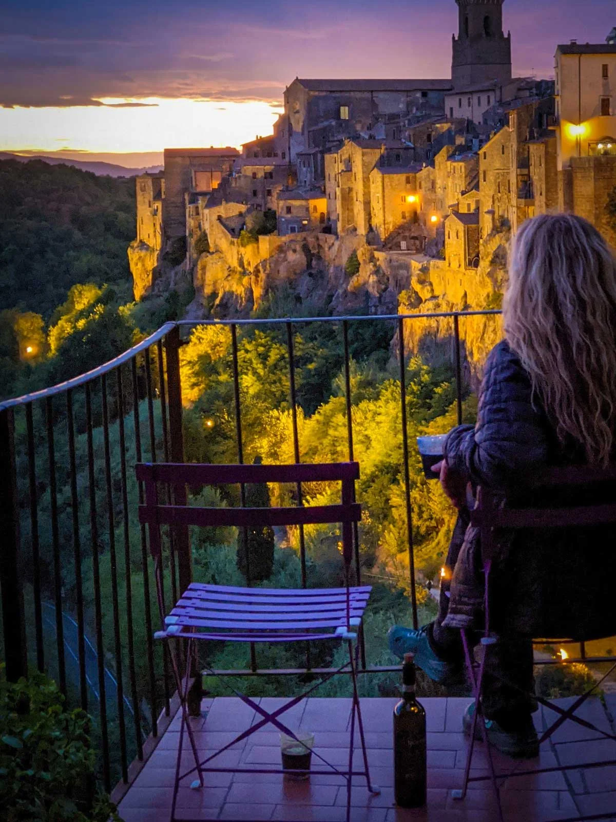 Flat with a balcony view over ancient Italian city at night.