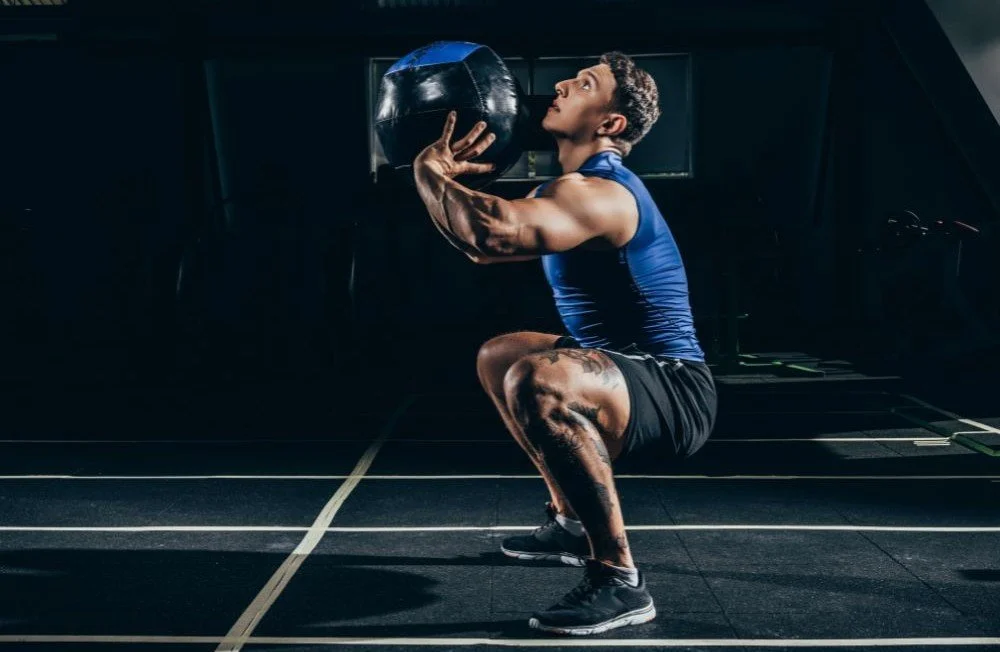 Image of an athlete throwing a ball upward