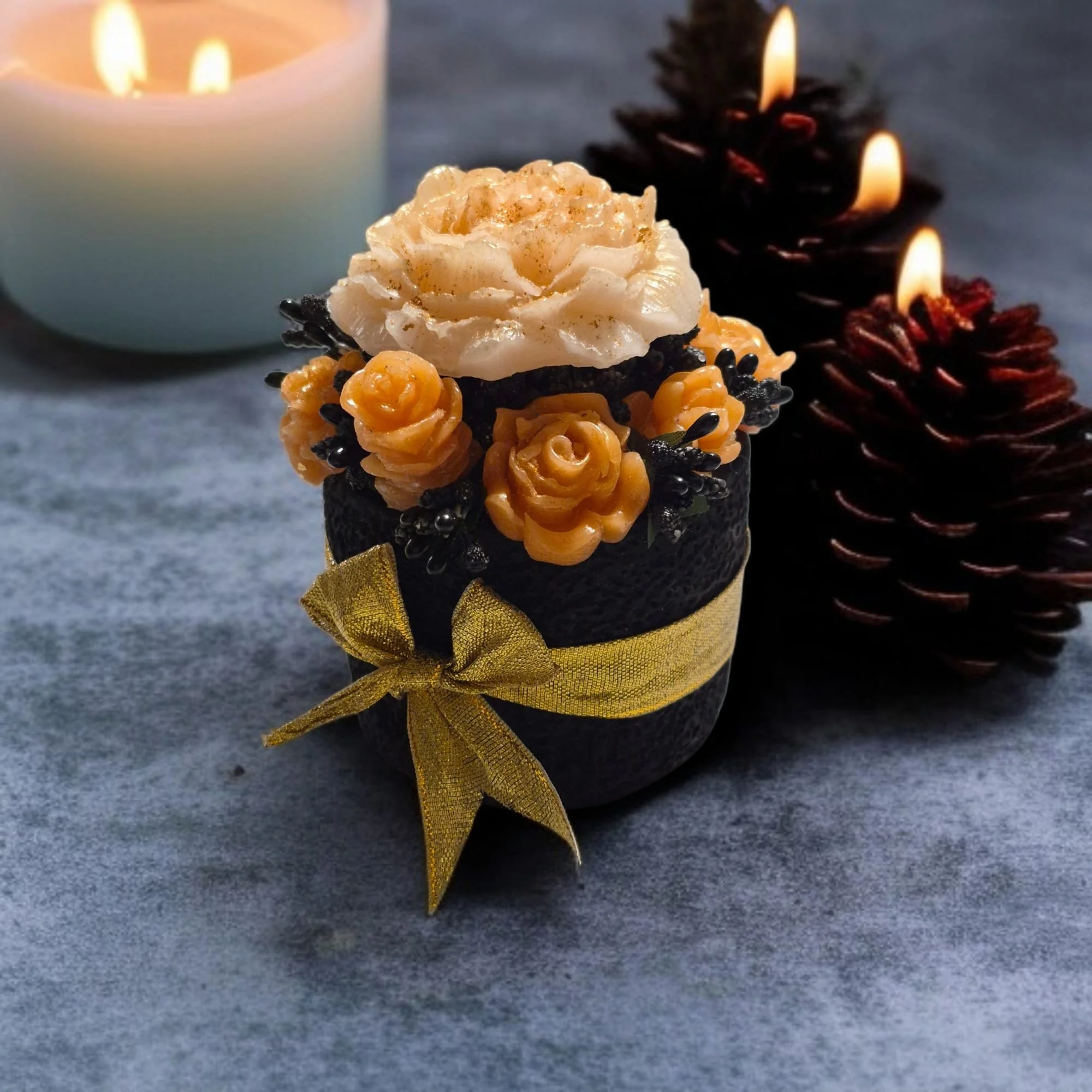 Decorative candle with floral and wreath candles in the background.