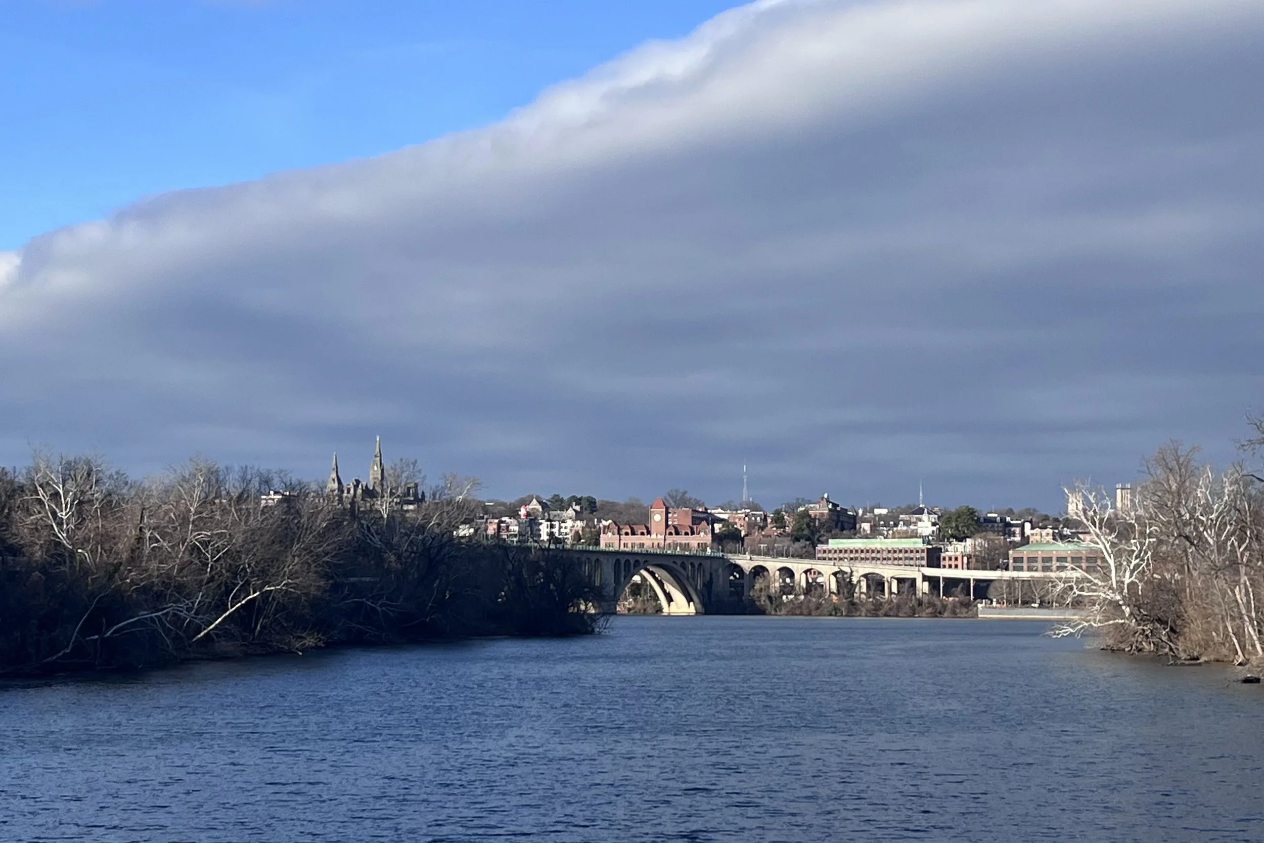 View across the Potomac River toward Georgetown, with the Key Bridge and city skyline visible.