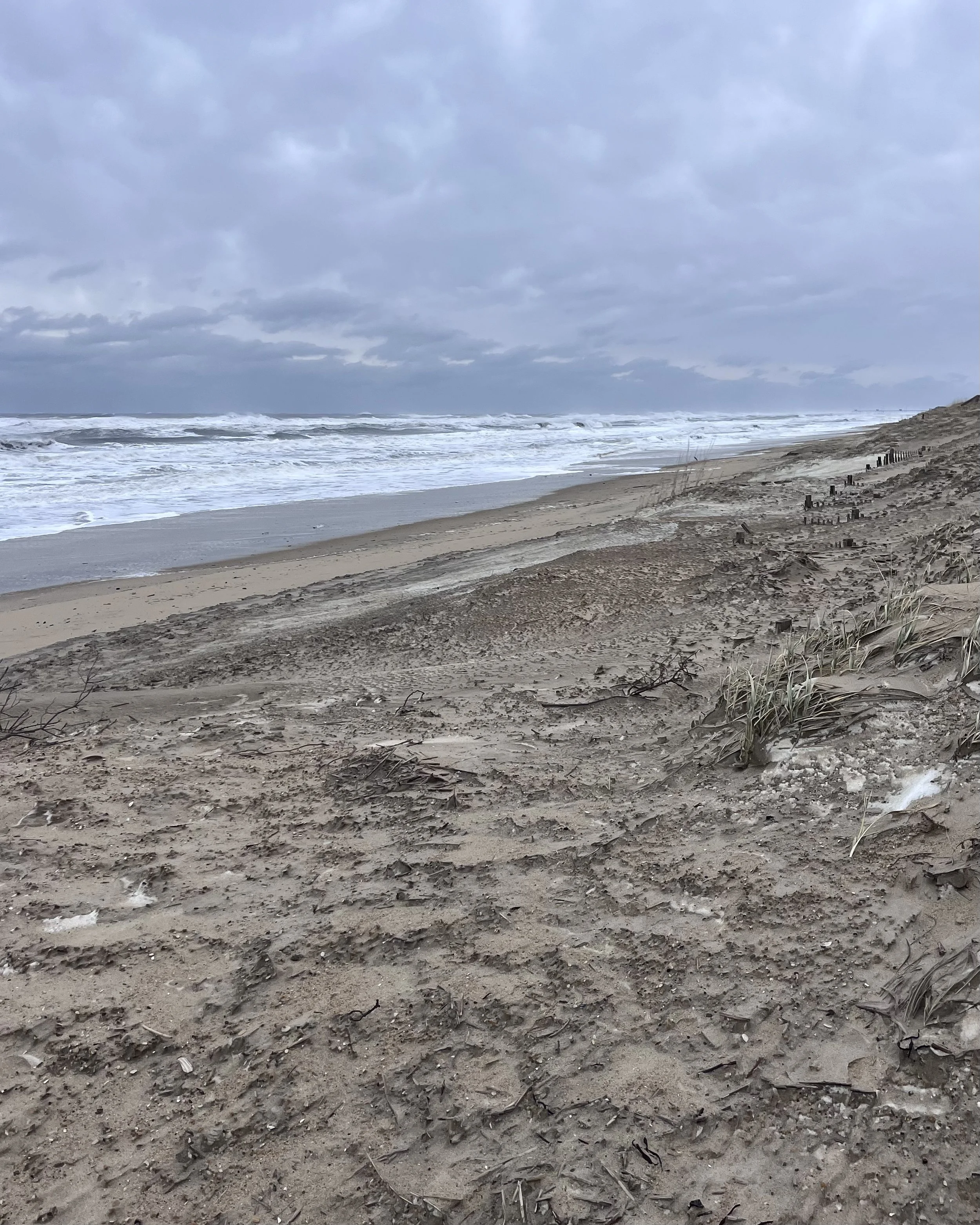 Stormy winter ocean with rough waves and an empty beach in the Outer Banks.