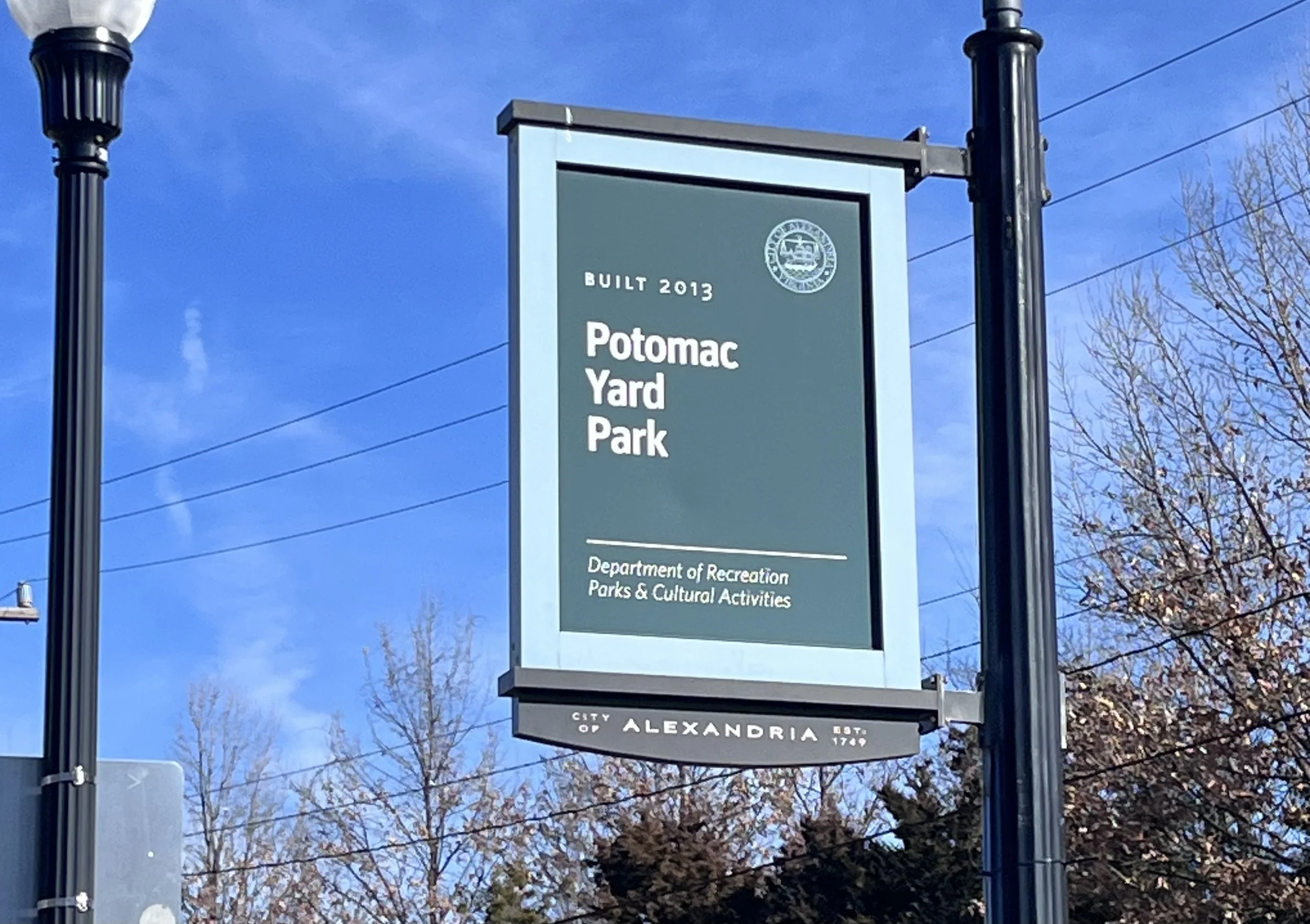 Sign for Potomac Yard Park in Alexandria, Virginia, marking access to connected walking paths.