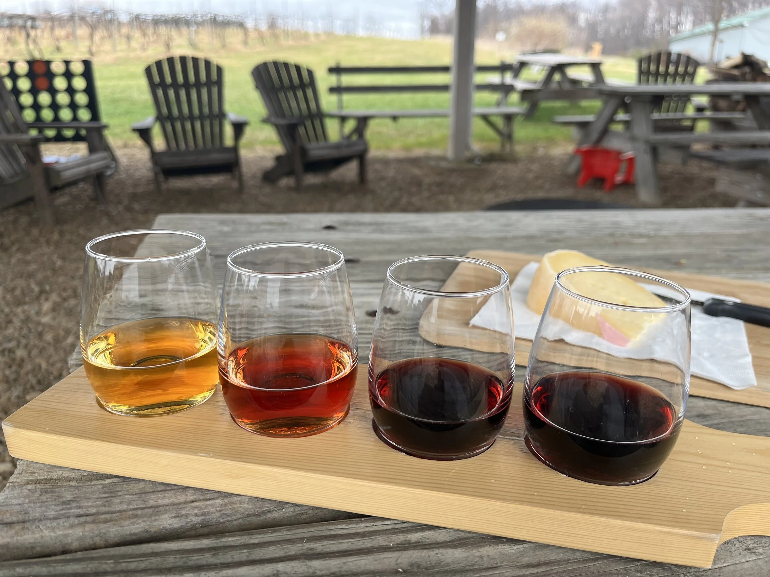 Wine flight and local cheese on an outdoor table overlooking the vines at Rockbridge Vineyard in Raphine, Virginia.