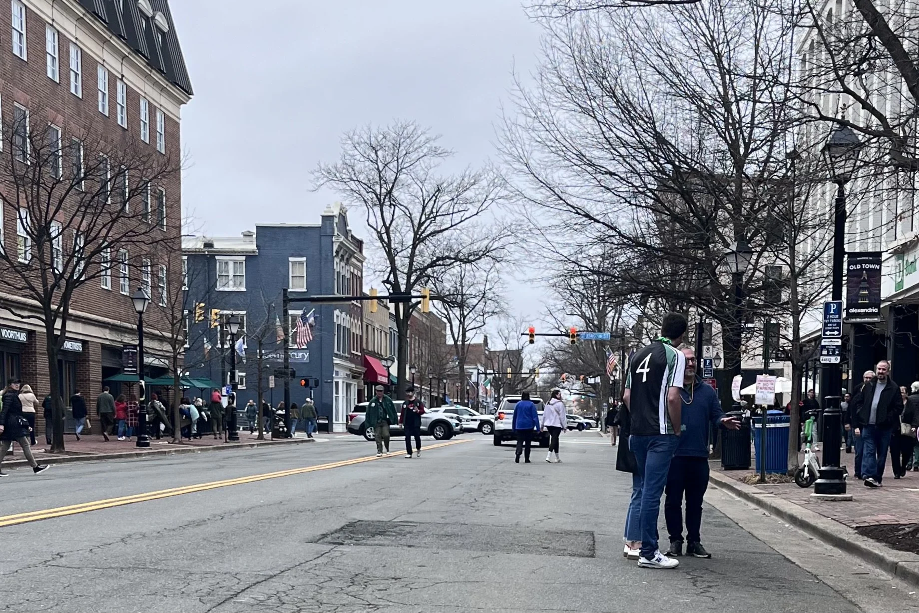 Busy King Street waterfront area with pedestrians, restaurants, and narrow walking space along the path