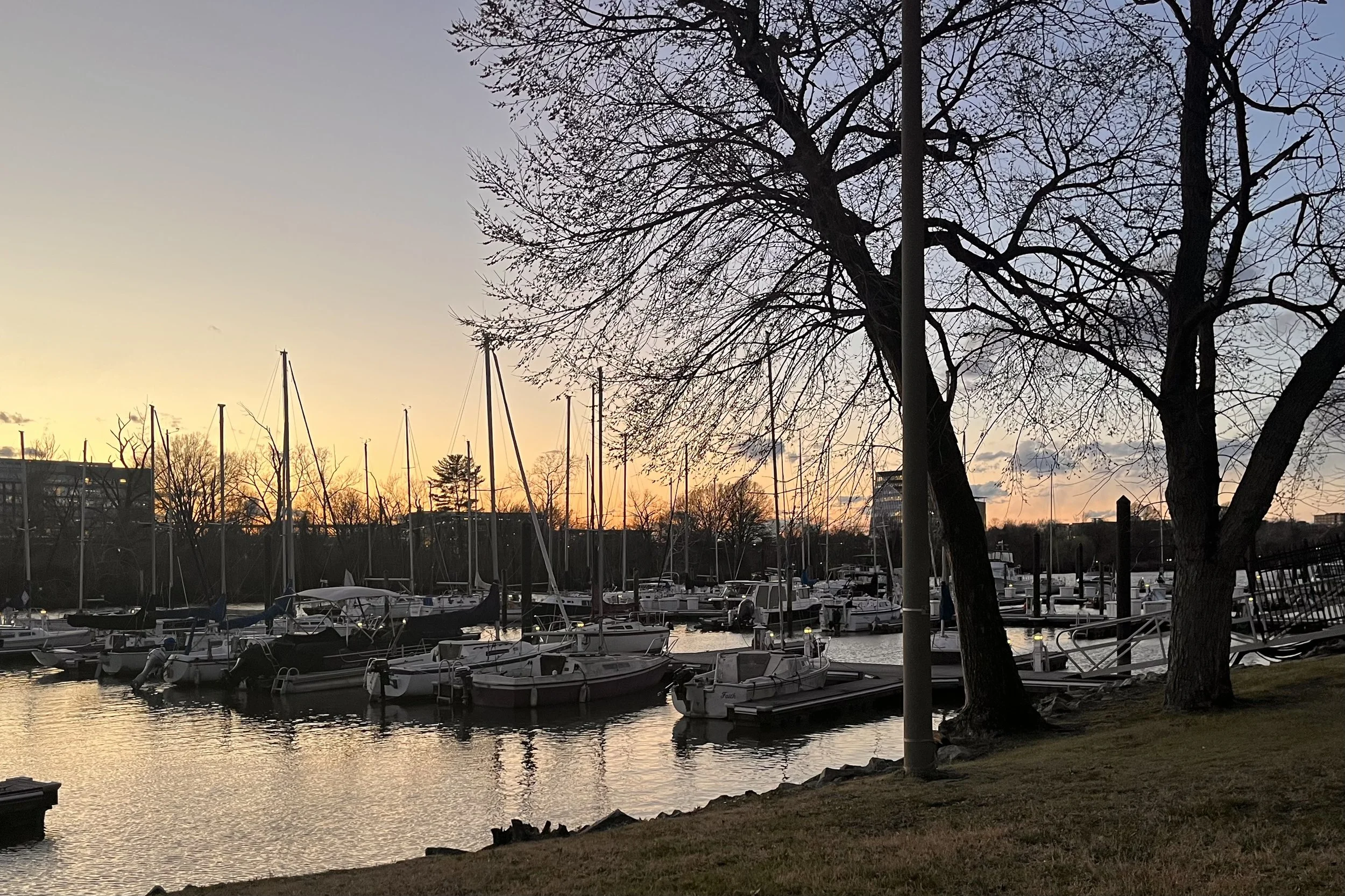 Sailboats and sunset light along the Potomac at Daingerfield Island in Alexandria, Virginia.