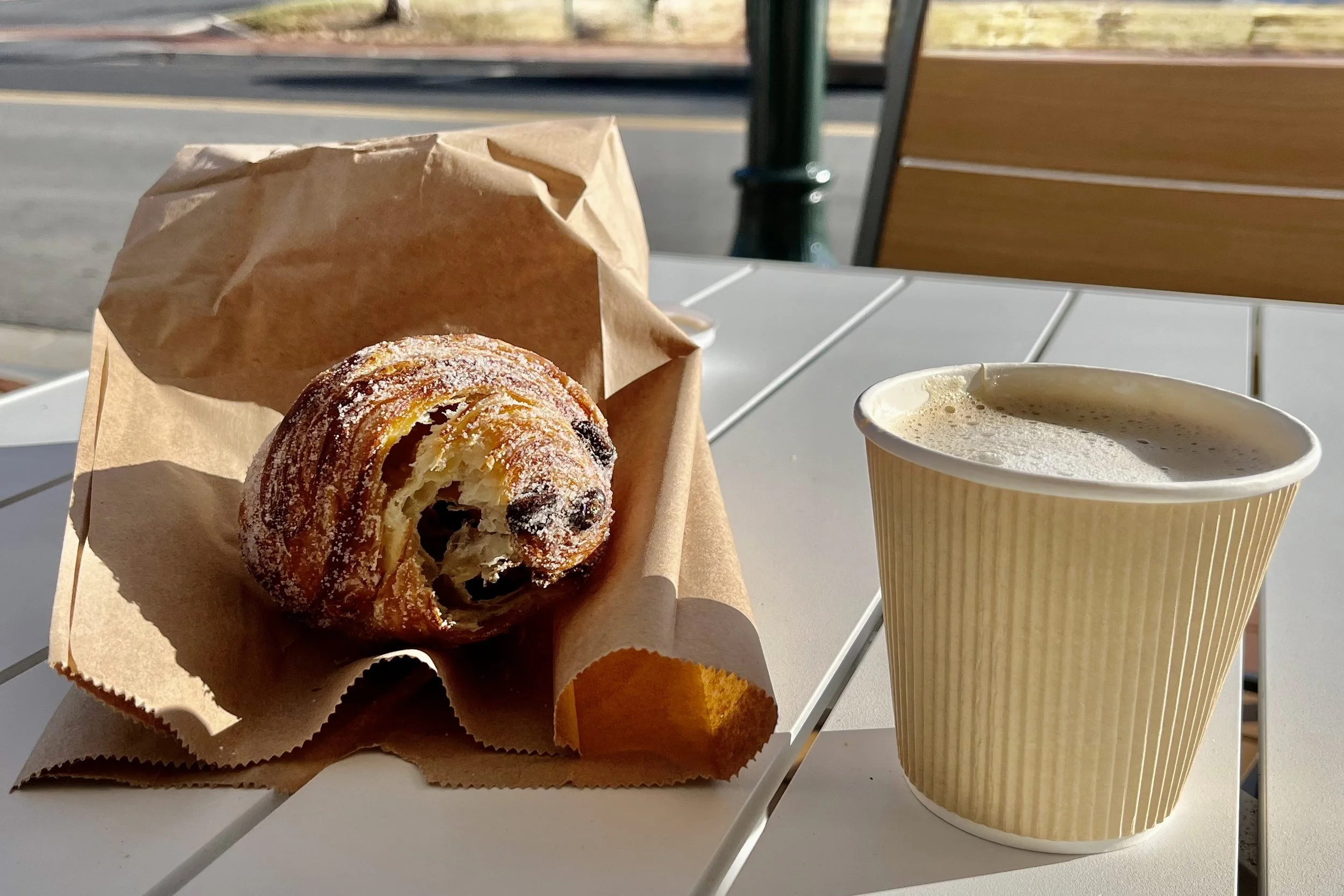 Chocolate pastry and coffee on an outdoor table at Magdalena Bake in Staunton.