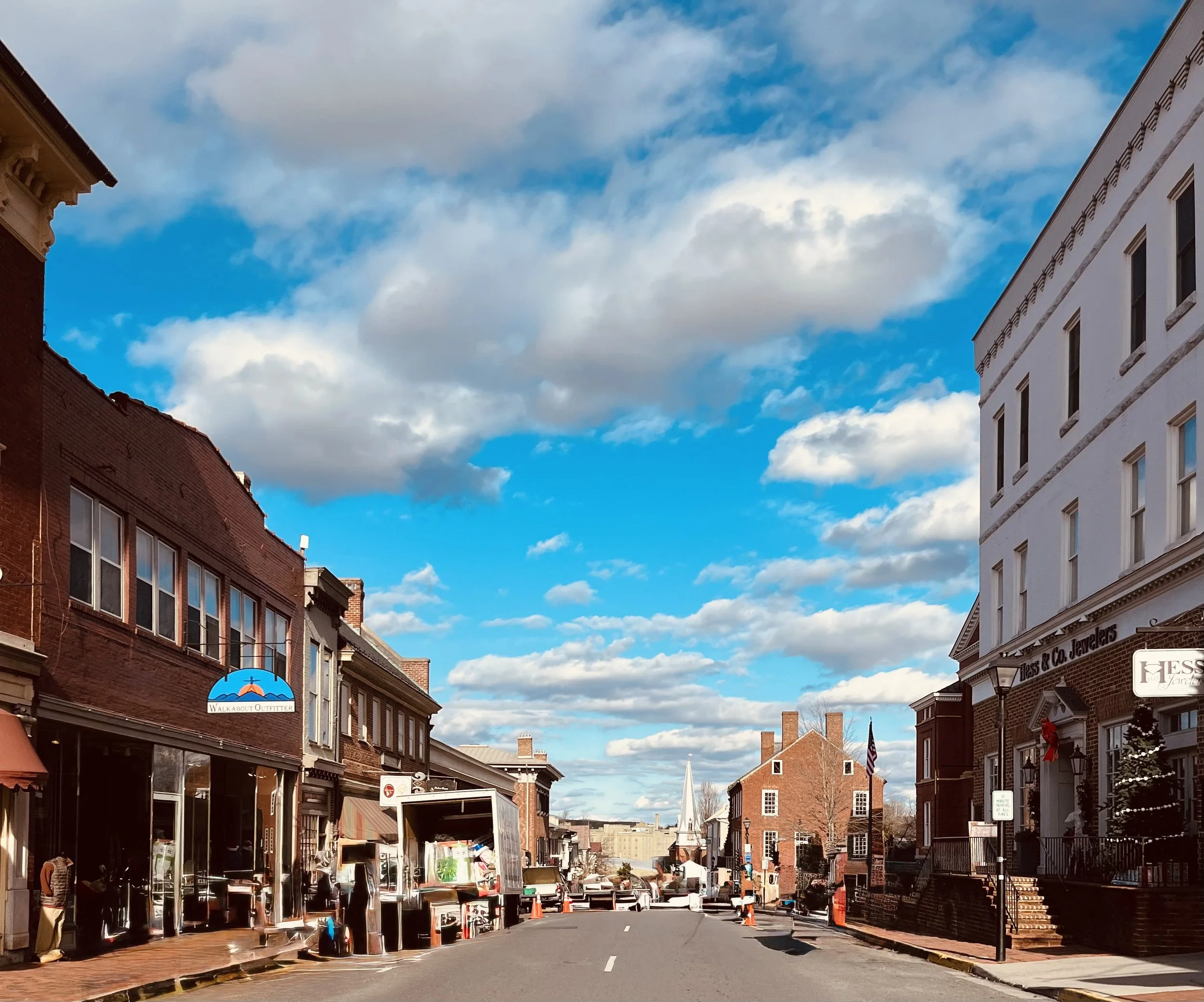 View looking down a street in downtown Lexington with red-brick sidewalks and historic storefronts