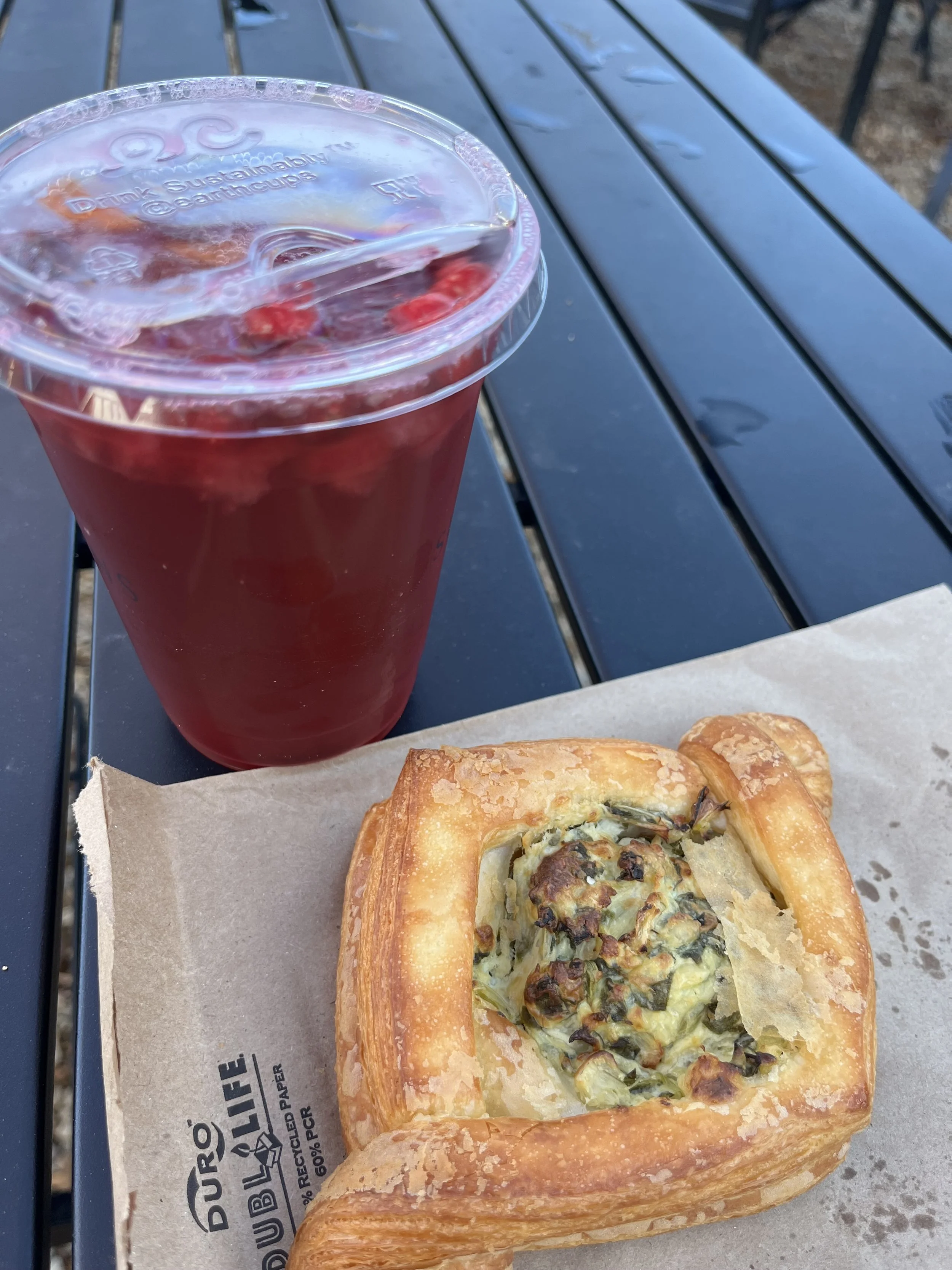 Outdoor seating at Seasons Coffee in Lexington, Virginia, with a table and drinks.