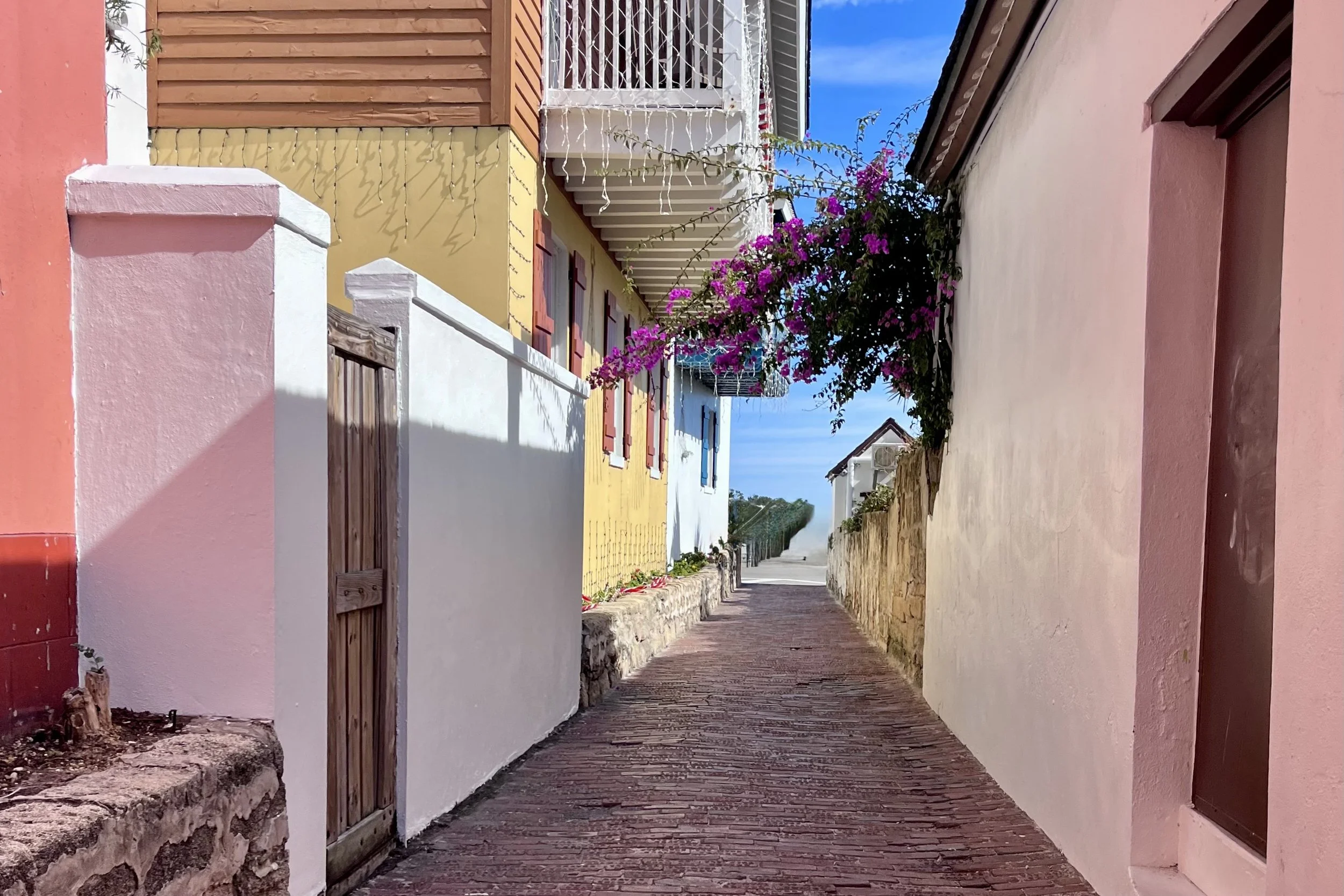 Pedestrian street in Old Town St. Augustine with narrow sidewalks and historic buildings.