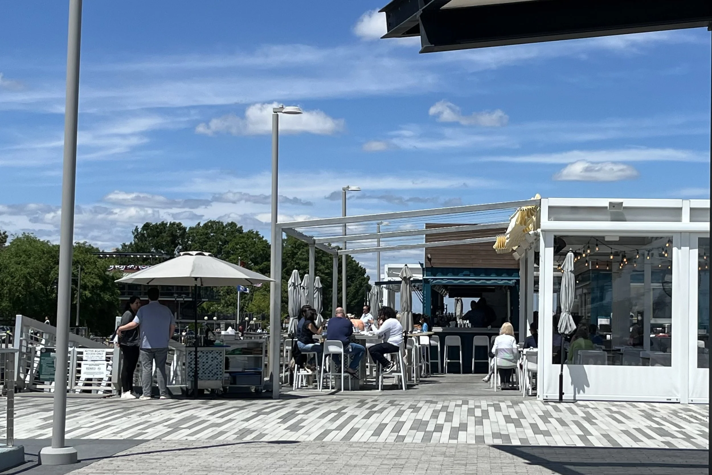 Pier-style outdoor restaurant seating over the Potomac River at BARCA in Old Town Alexandria.