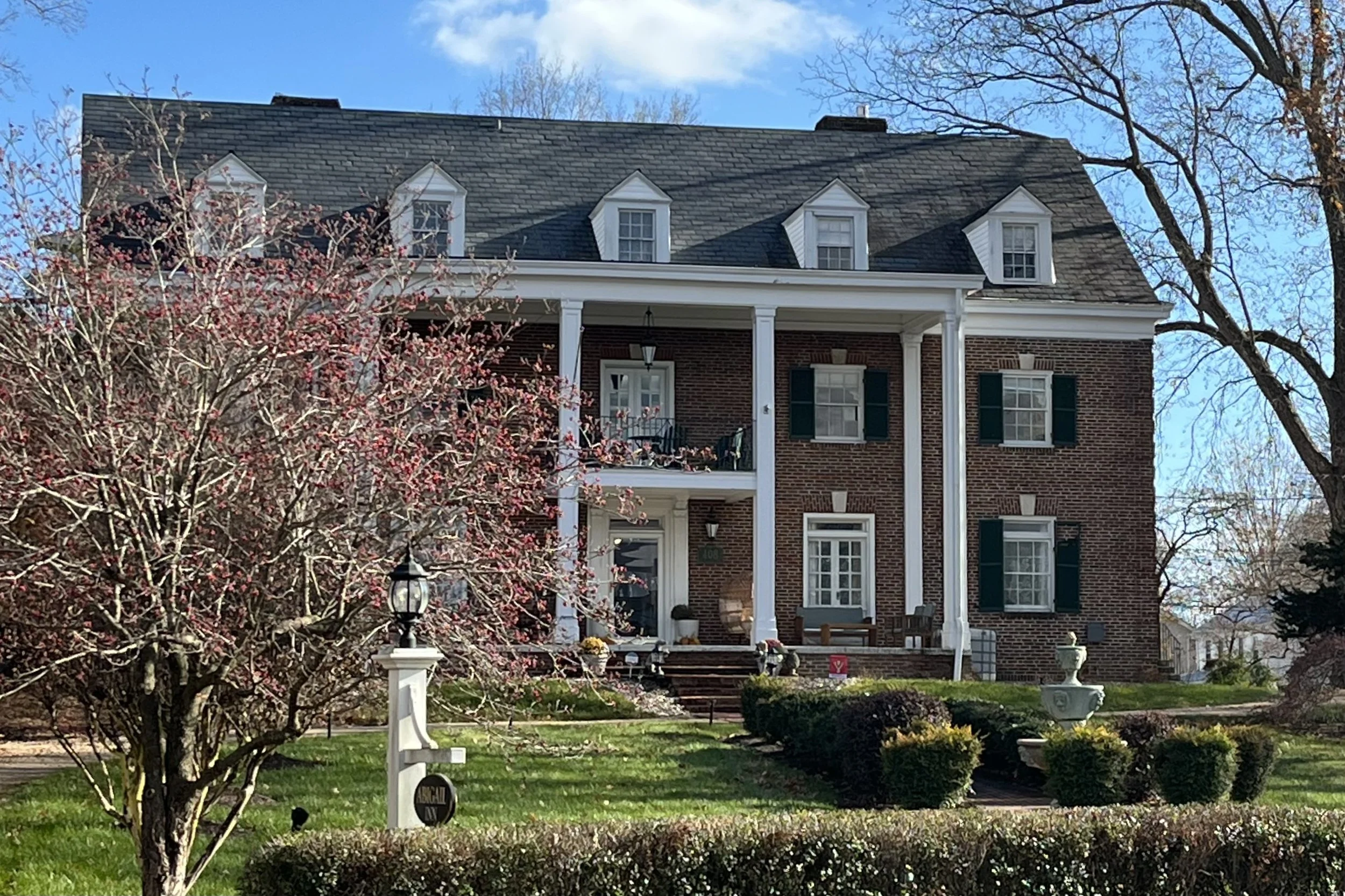 The brick exterior and front porch of The Abigail Inn in Lexington, Virginia.
