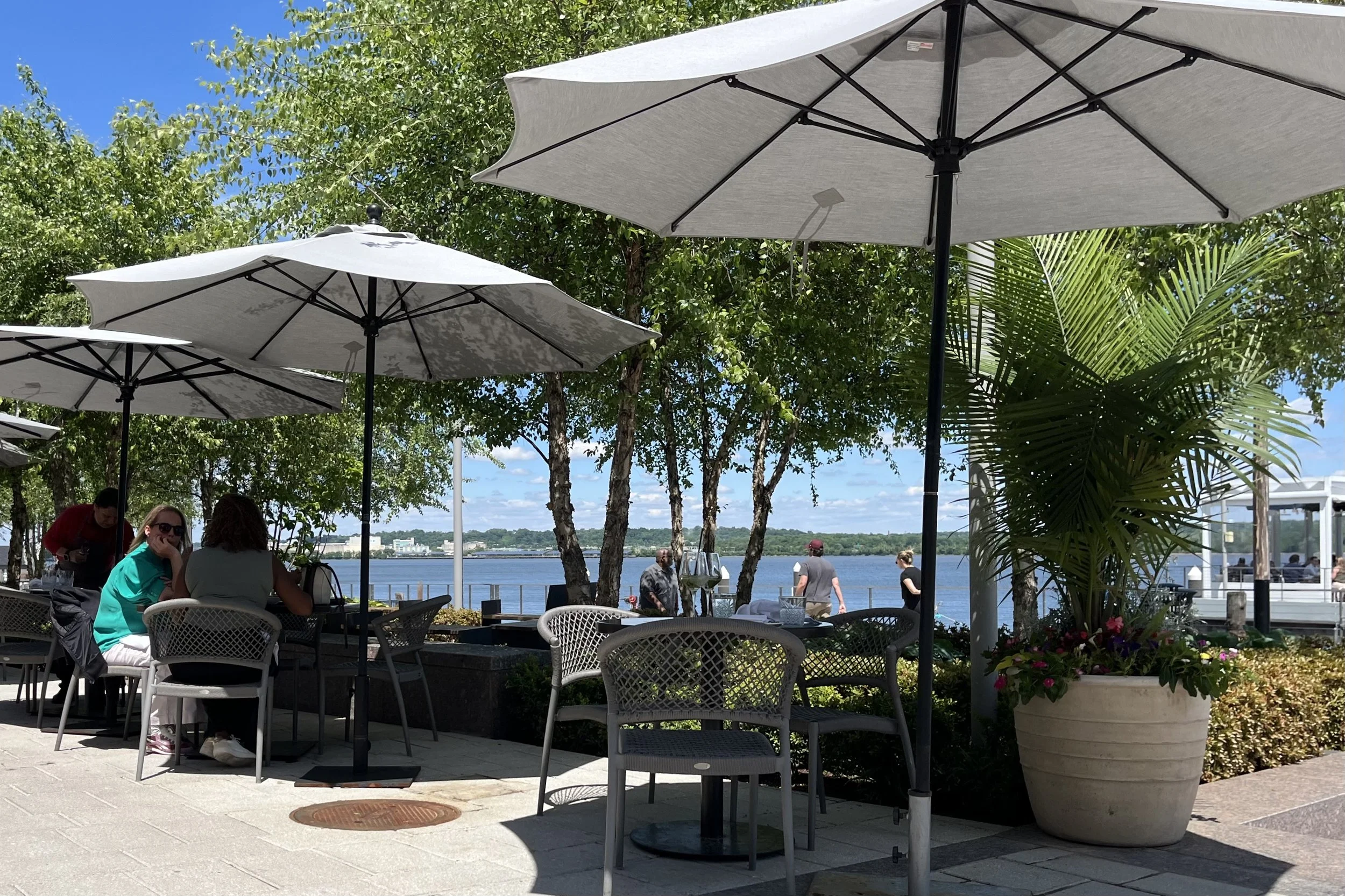 Outdoor patio seating at Ada’s on the River in Old Town Alexandria beside the Potomac River.