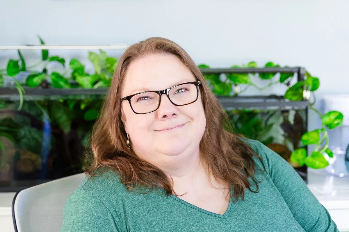 Close-up image of Karen smiling with plants in background.