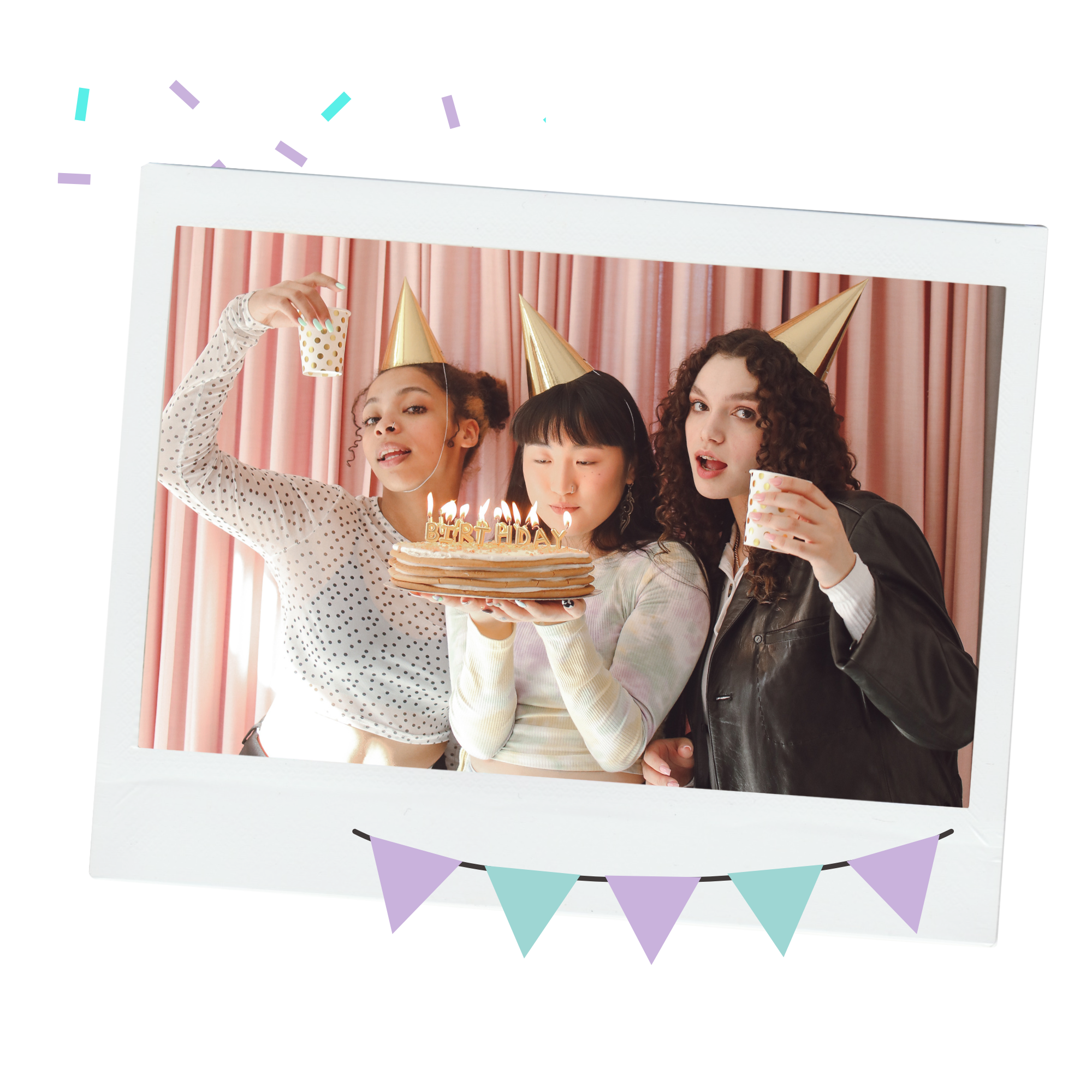 Three young women at a birthday celebration, wearing party hats and holding a birthday cake with lit candles, against a pink curtain backdrop.