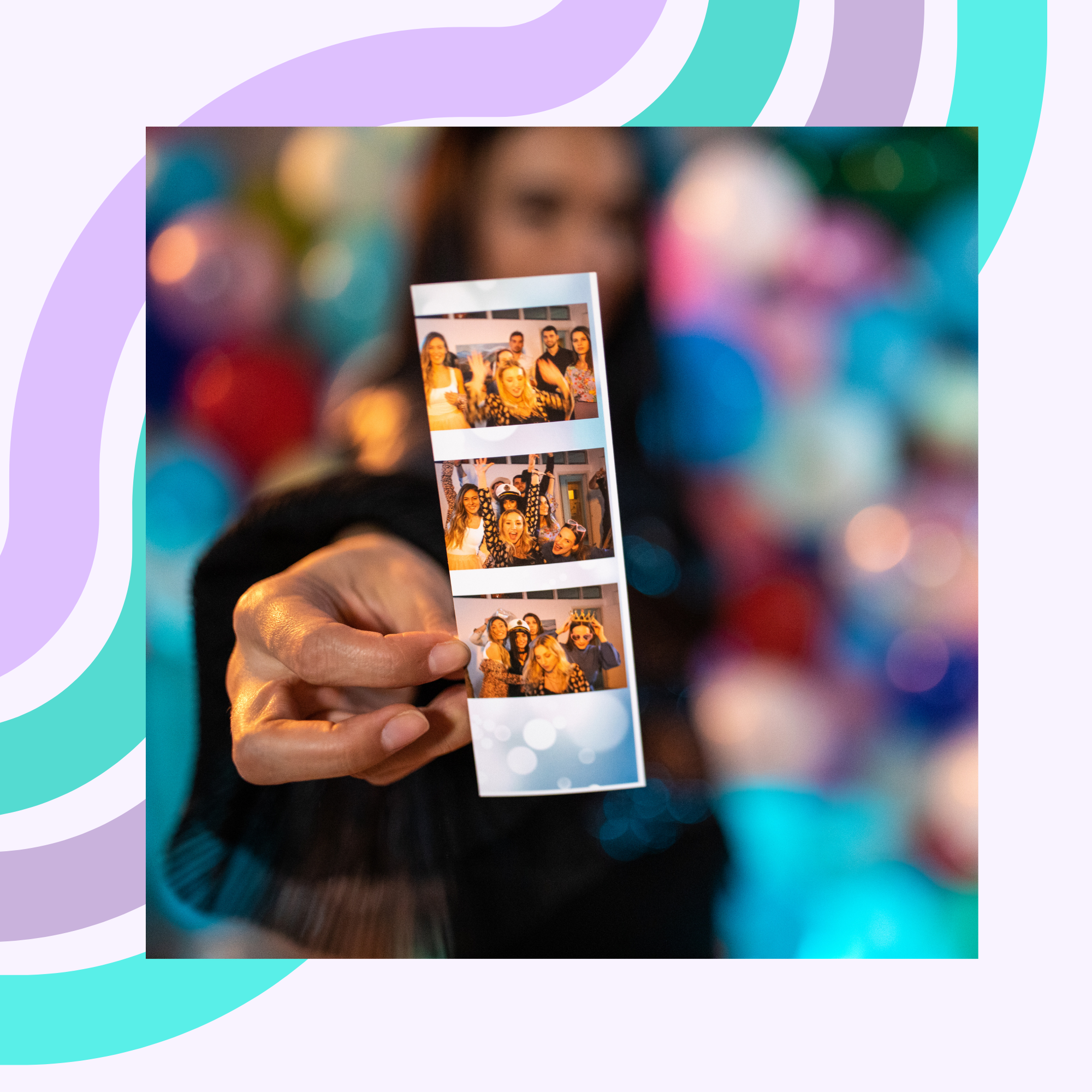 Person holding a photo booth strip with four pictures of a group celebrating at a party, background decorated with colorful bokeh lights.