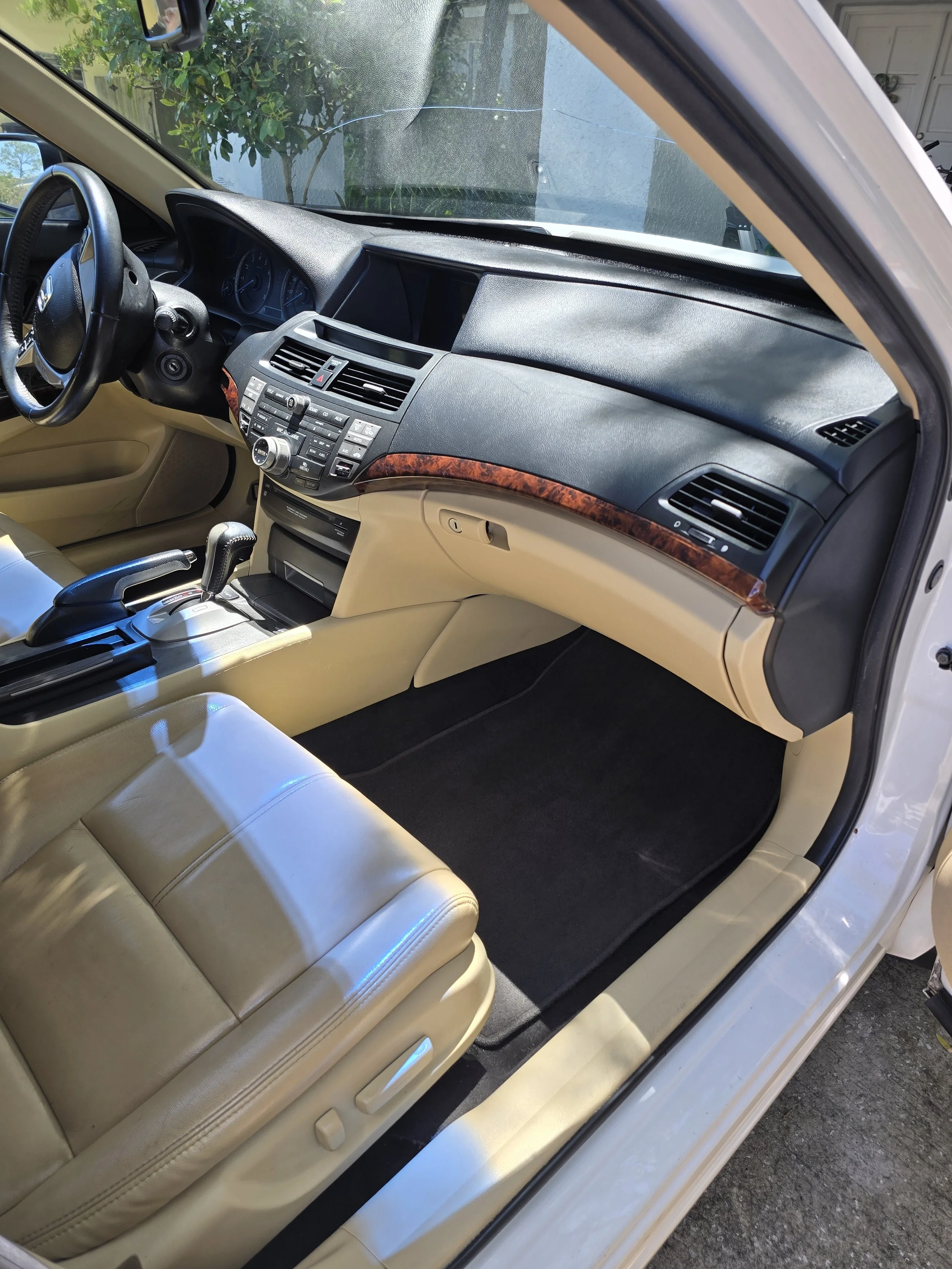 The interior of a car, showing the front passenger seat, dashboard, steering wheel, and center console.