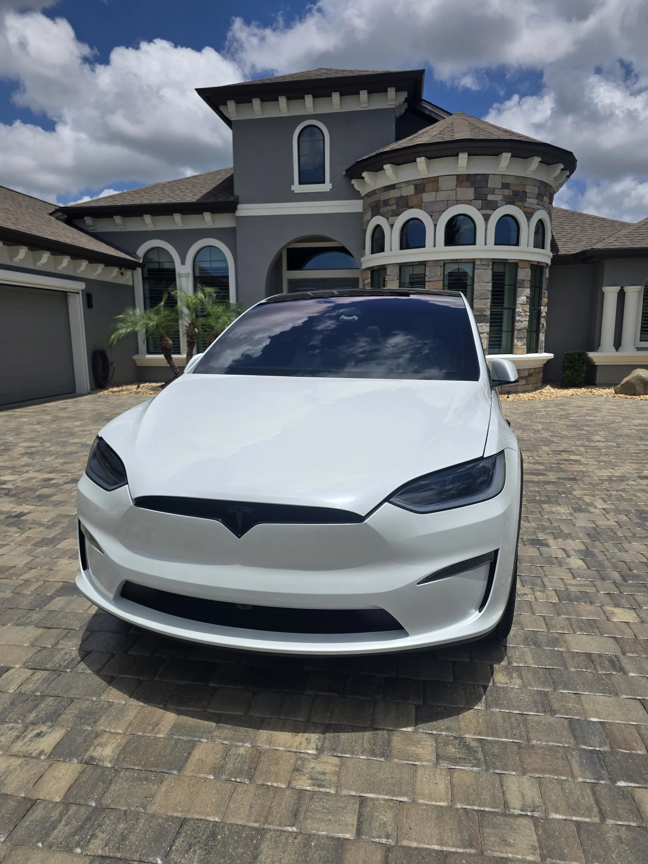 White Tesla Model Y exterior detail completed at a Palm Coast home by R.K. Mobile Detailing