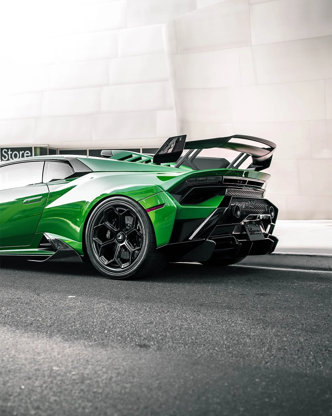 Green Lamborghini sports car parked outside.