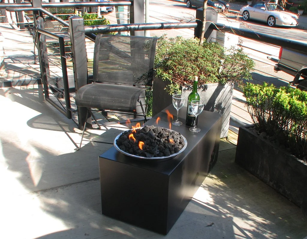 Stainless steel and steel with powder coat finish. 37"l x 15"w x 18"h. Propane fueled fire table