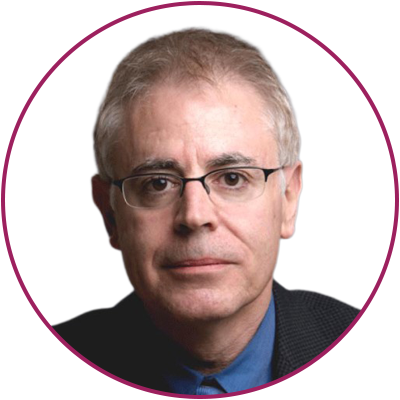 A middle-aged man with glasses, short gray hair, wearing a dark suit and a blue shirt, looking directly at the camera.