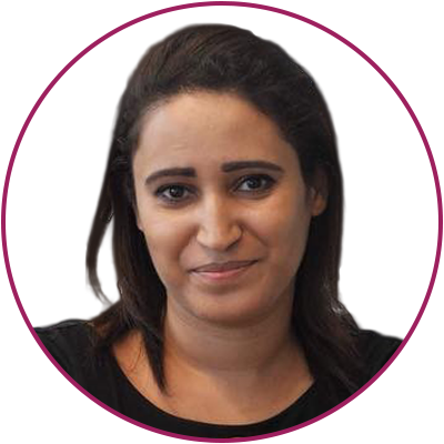 Close-up portrait of a woman with dark hair and a slight smile, wearing a black top, against a white background with a purple circular border.