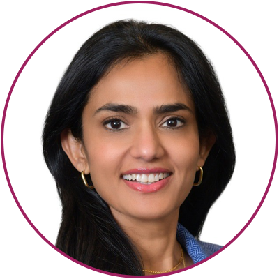 A woman with long dark hair, wearing a blue top and gold hoop earrings, smiling against a white background with a purple circle border.
