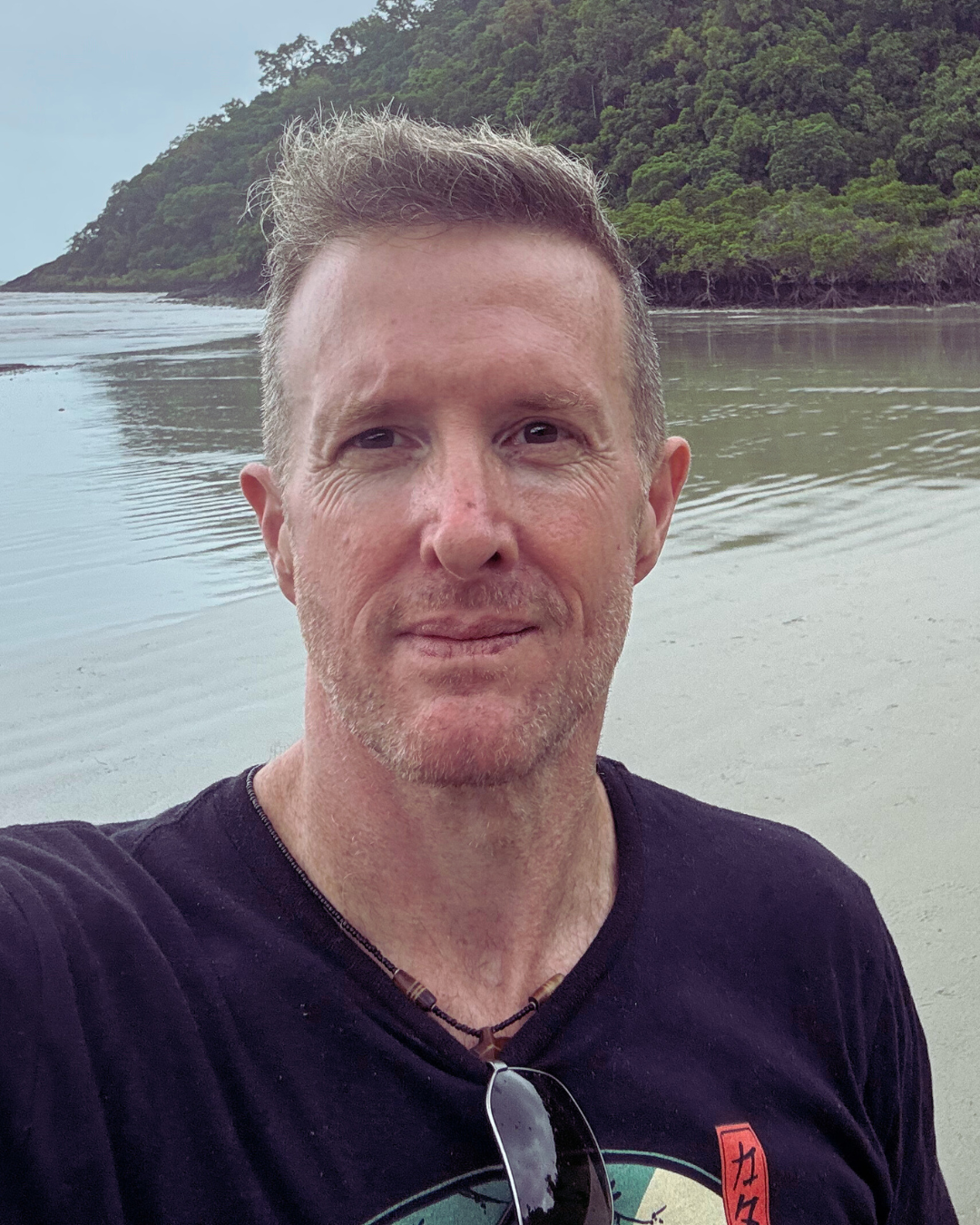 Jeremy Aitken standing on a beach in Far North Queensland