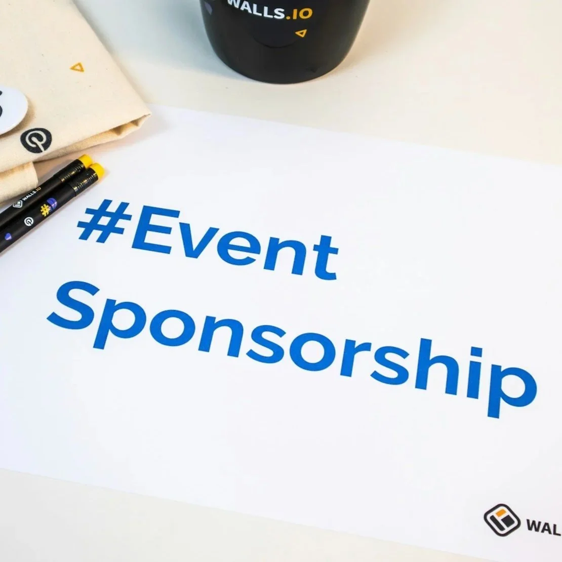 A white sheet of paper with the words '#Event Sponsorship' written in large blue font.