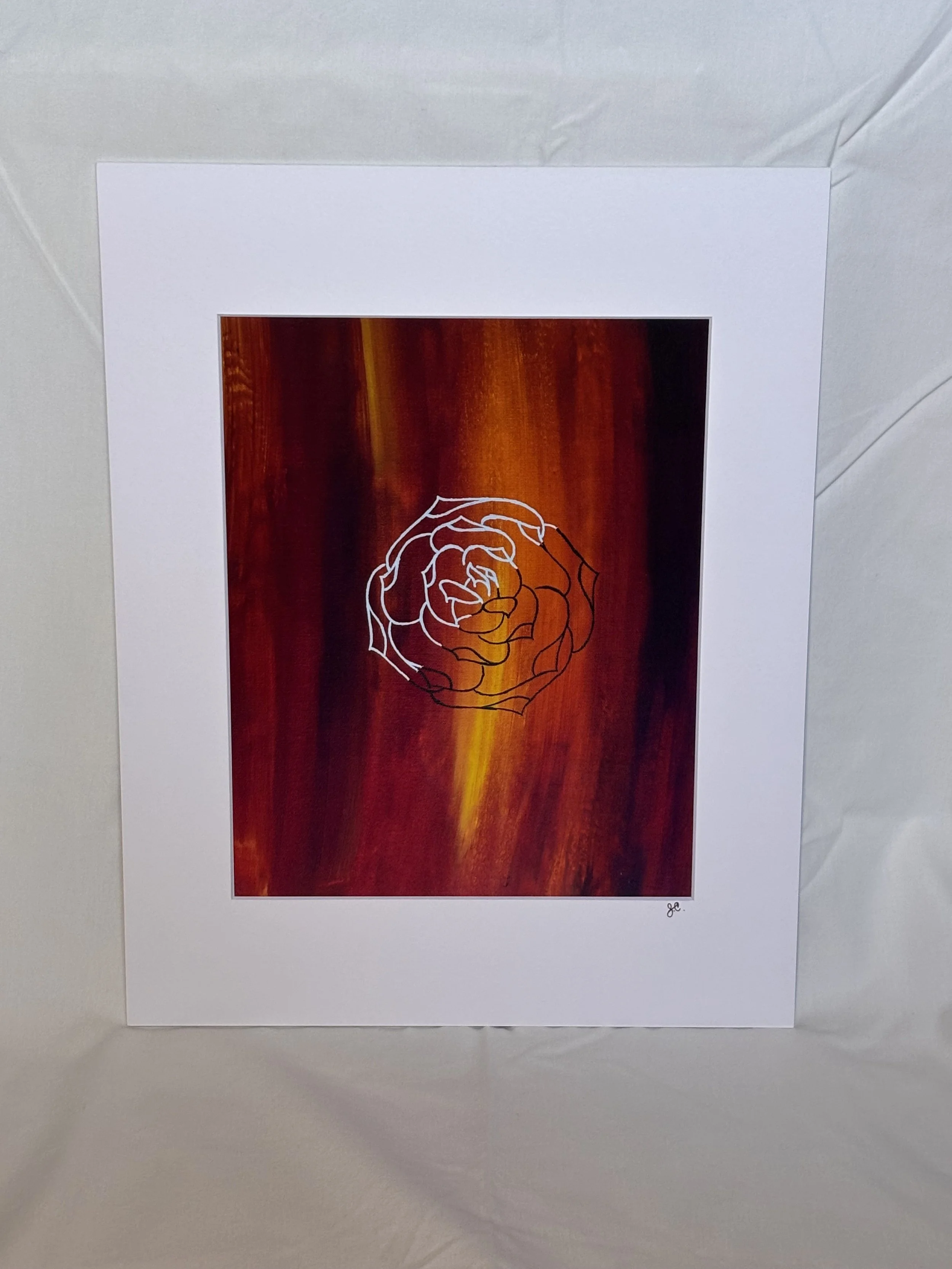 Art print of a black and white rose outline on a red and orange background with a white mat border
