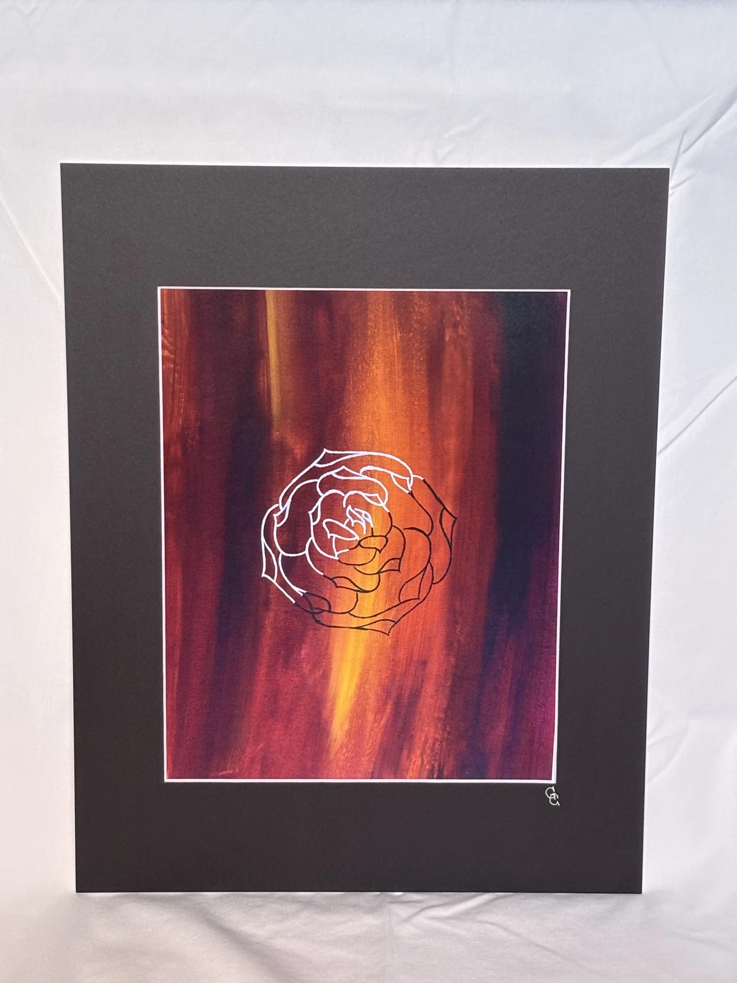 Art print of a black and white rose outline on a red and orange background with a black mat border