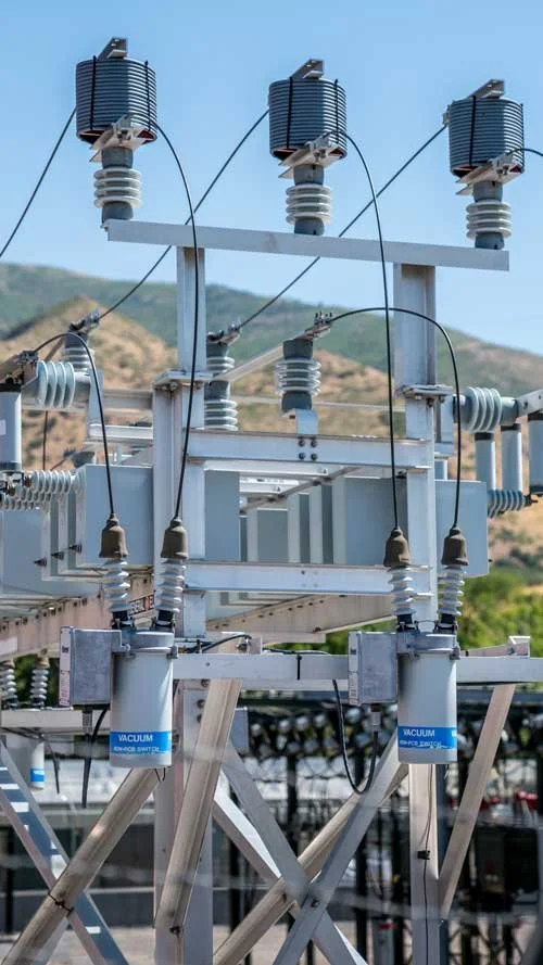 High voltage disconnect switches and insulators at a Utah substation, engineered by Lynk Engineers.