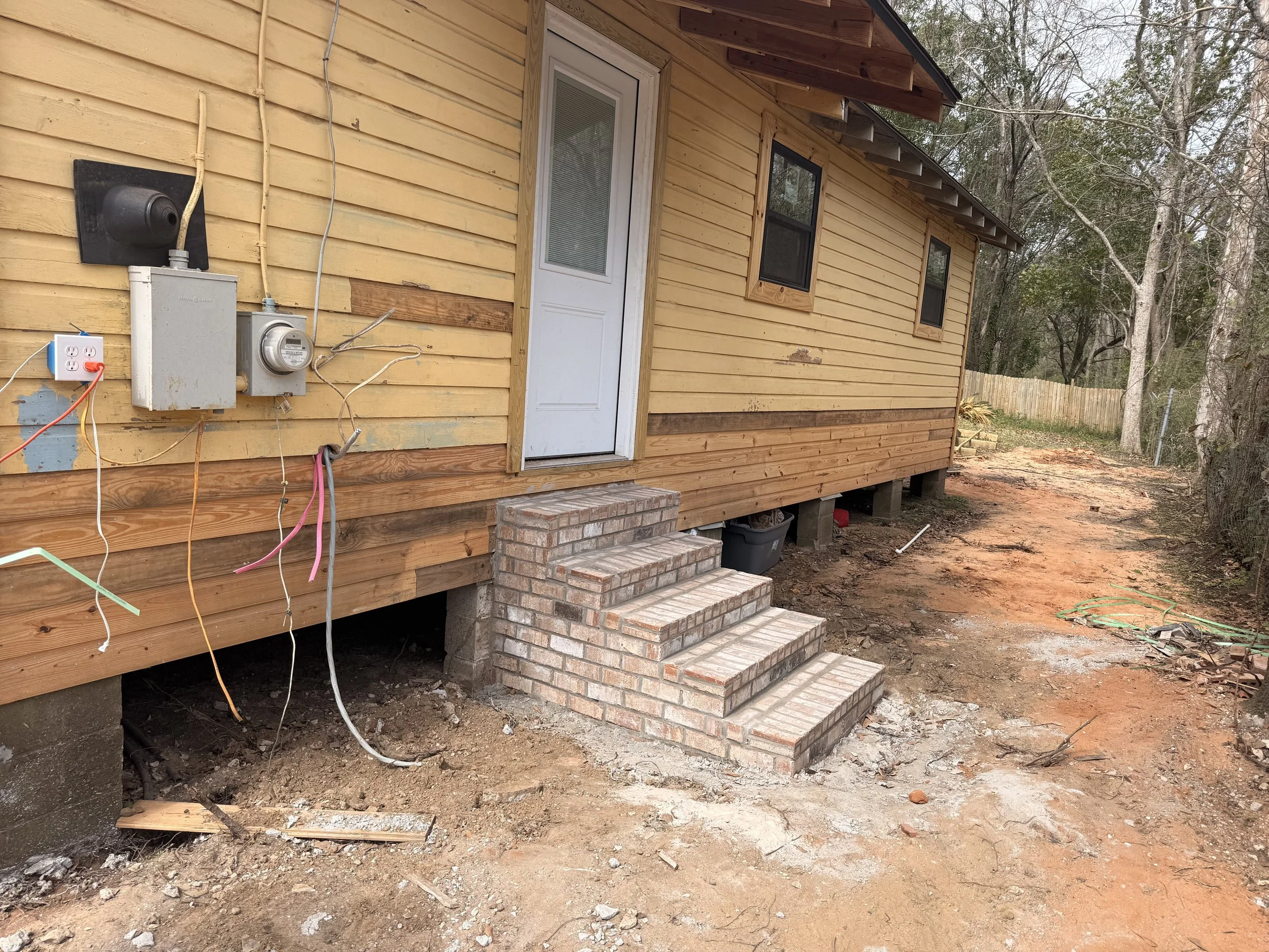 Due to landscape home was lifted and new weather seals added. Stairs were upgraded for a more modern appeal.