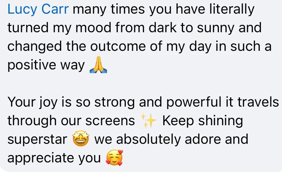 Screenshot of a motivational message praising Lucy Carr for her positive influence and shining personality, with emojis.