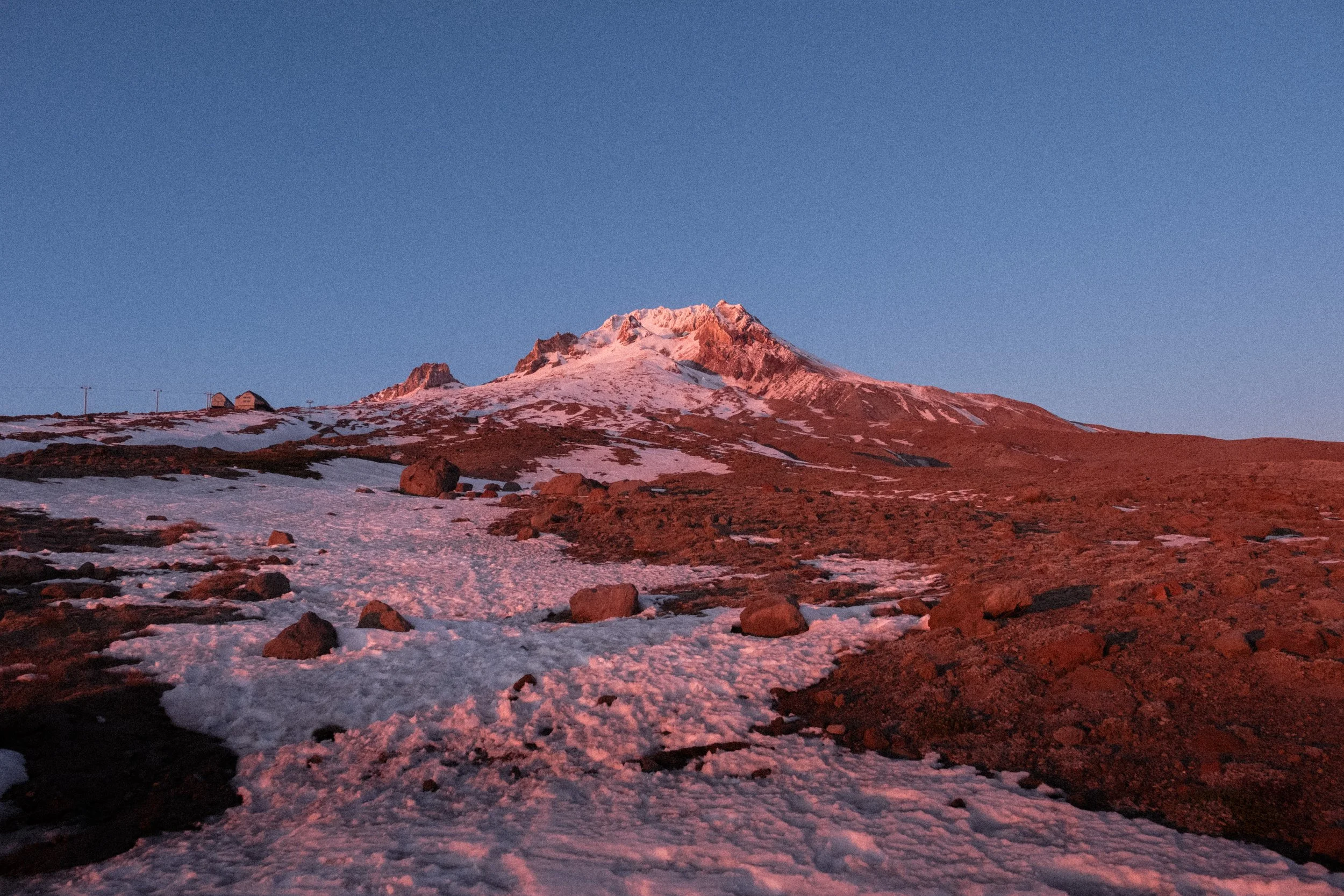 AJ Miranda Photography Vibrant PNW Alpine Photography capturing the snow-covered summit of Mt. Hood, Oregon, in October 2023, showcasing dramatic red and orange lighting.