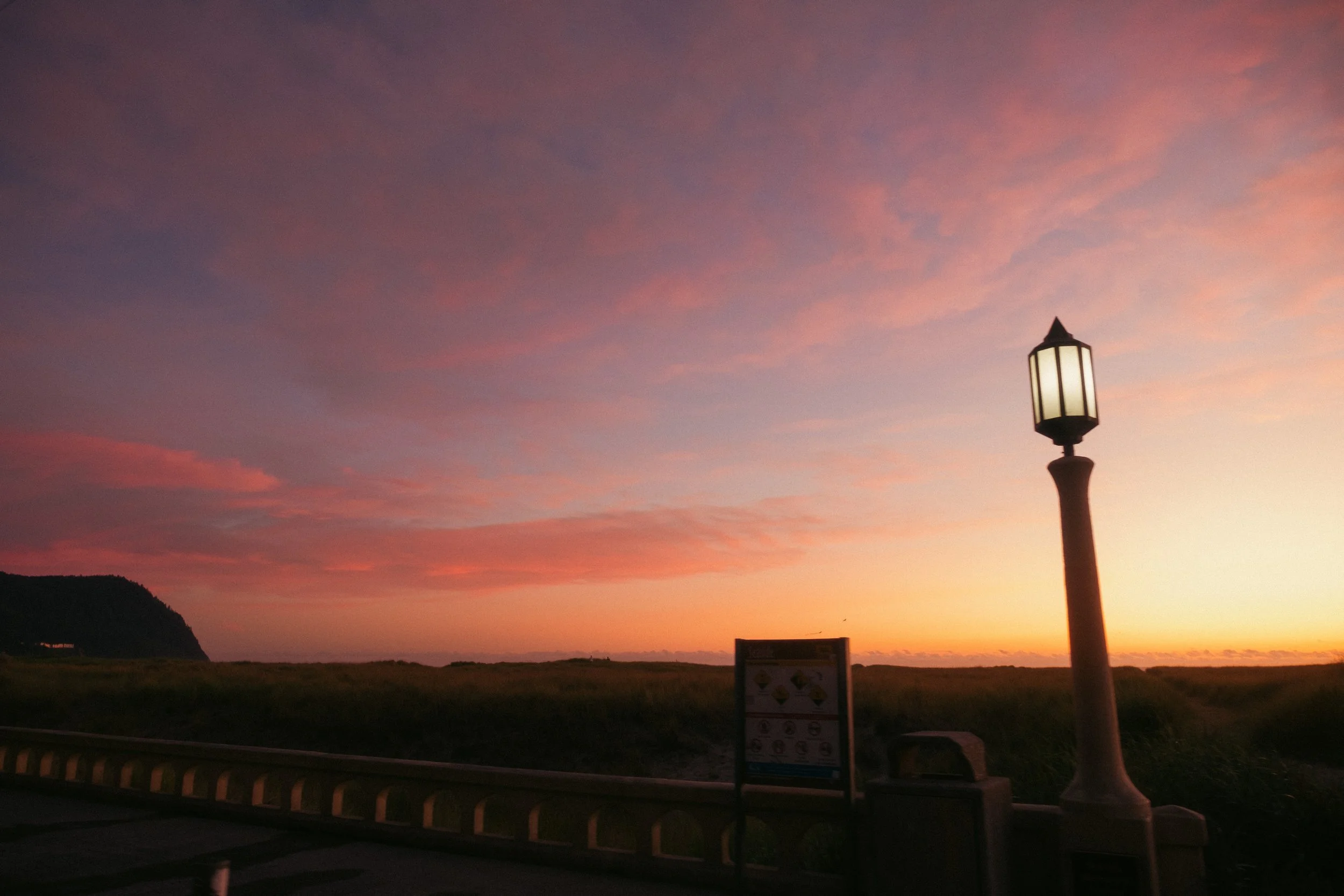 AJ Miranda Long-exposure, cinematic photographs documenting the intense 4th of July fireworks display and grand finale over Seaside, Oregon Coast in 2025. This dark and moody film series captures the chaotic, warzone-like atmosphere of the crowded be
