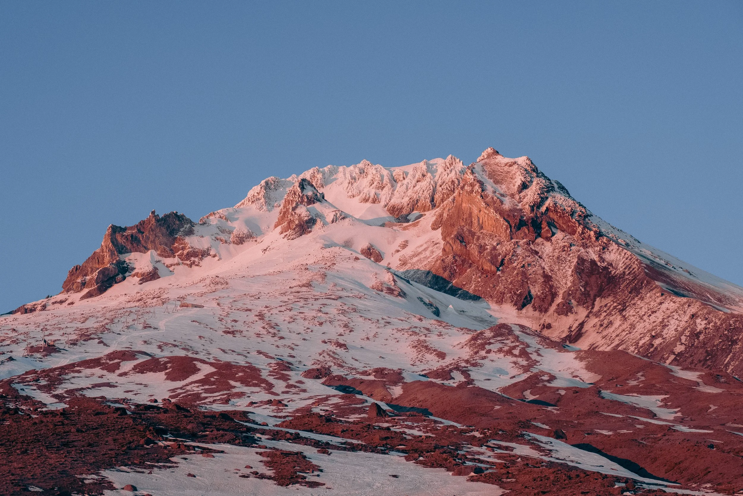 AJ Miranda Photography Vibrant PNW Alpine Photography capturing the snow-covered summit of Mt. Hood, Oregon, in October 2023, showcasing dramatic red and orange lighting.