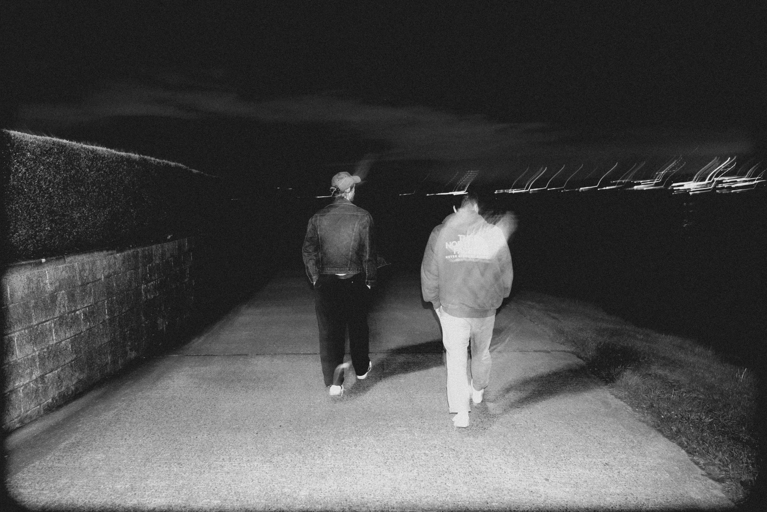 High-contrast candid flash photography of the EL Wedos band in Vancouver, WA. Unpolished style capturing authentic, unfiltered reality and personality against the dark, blooming PNW nature.