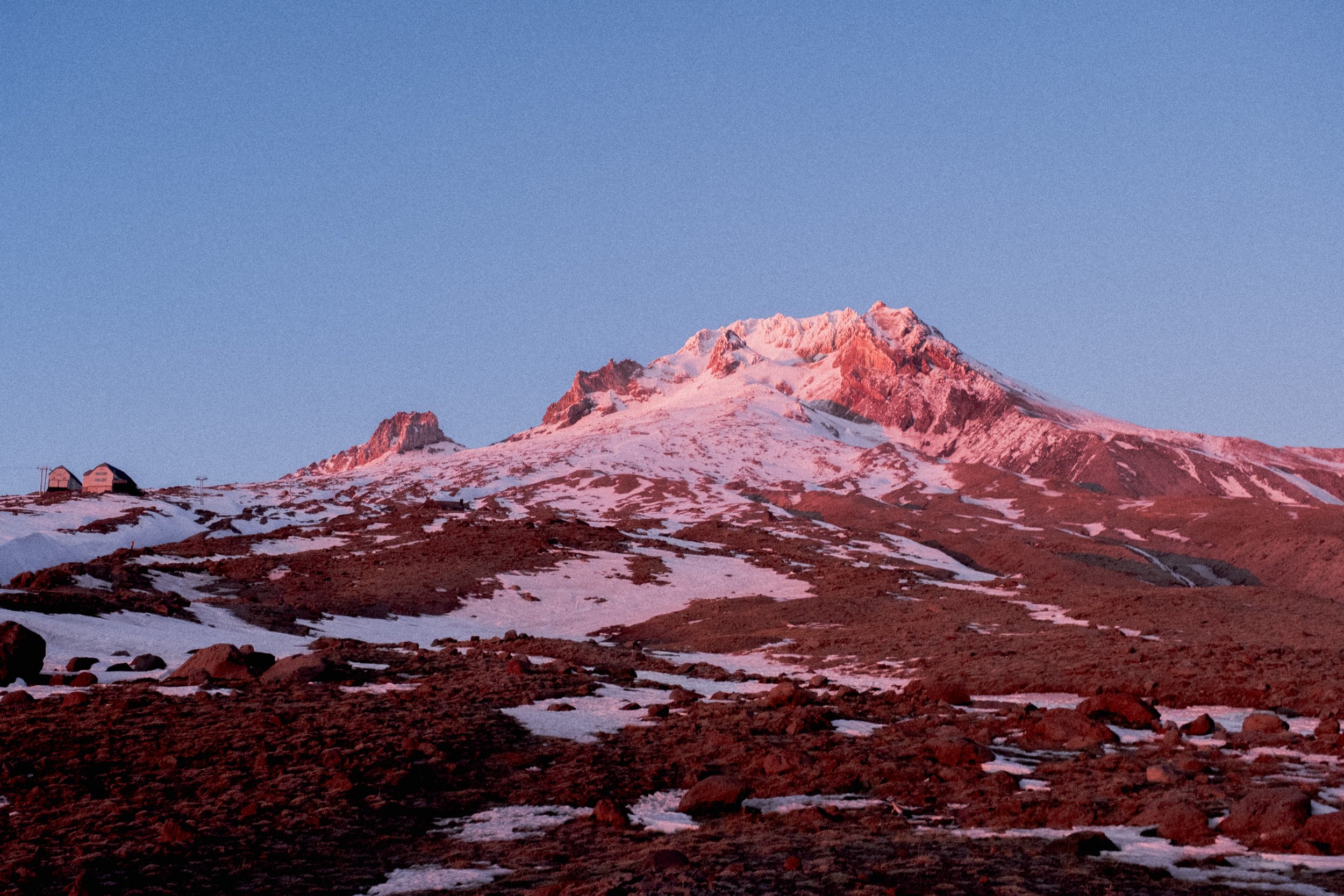 AJ Miranda Photography Vibrant PNW Alpine Photography capturing the snow-covered summit of Mt. Hood, Oregon, in October 2023, showcasing dramatic red and orange lighting.